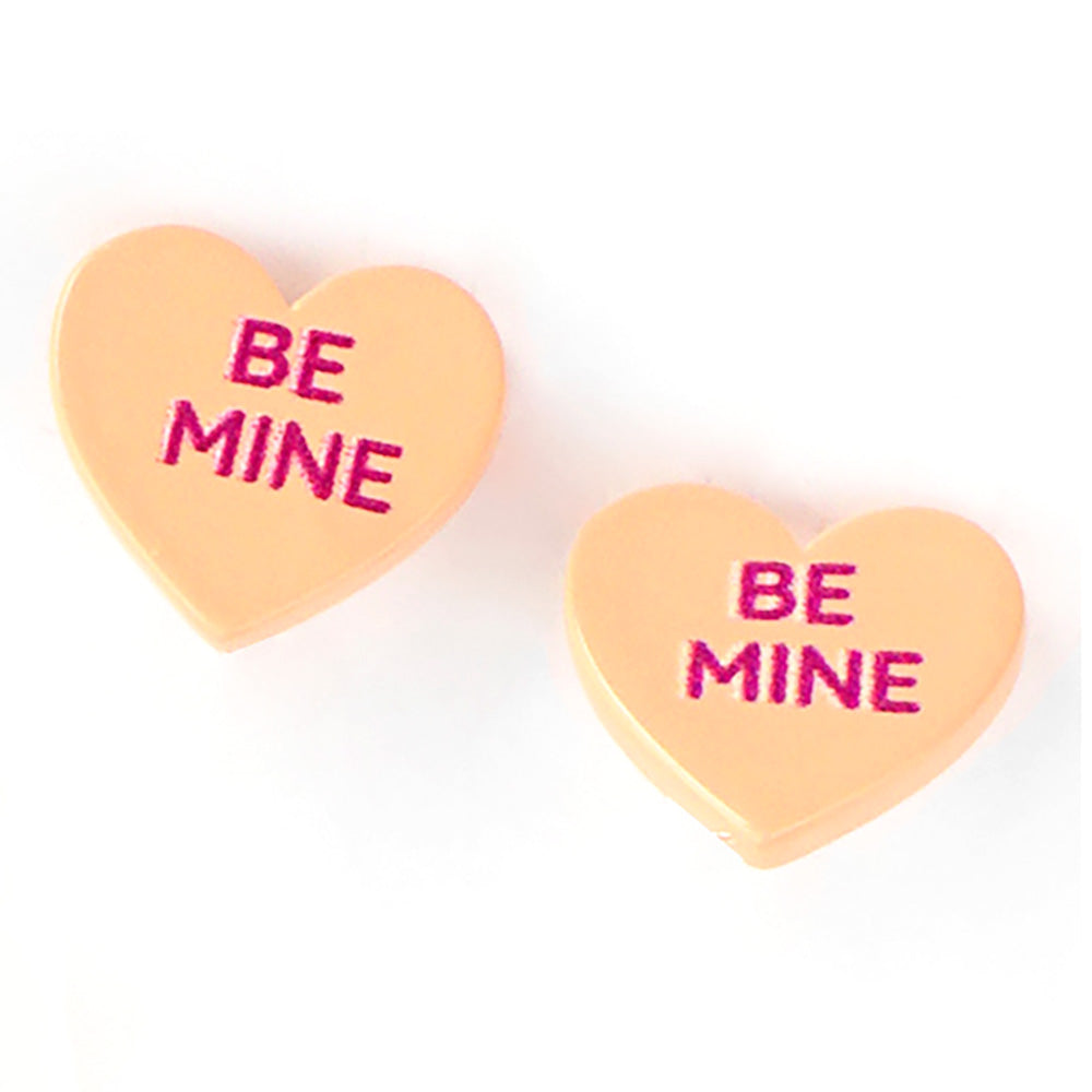Be Mine Message Heart Stud Earrings are a charming way to express your love. Expertly crafted, these intricately designed hearts feature the words 'Be Mine' elegantly etched into them. Made with high-quality materials, these earrings are the perfect gift to show your affection.