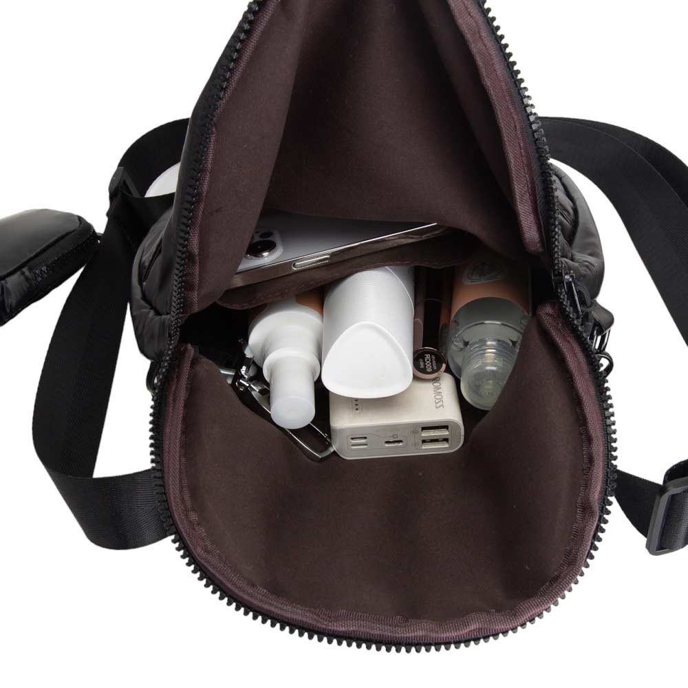 Black Puffer Half Moon Crossbody Bag, the lightweight, stylish design features a durable water-resistant nylon that is perfect for outdoor activities. The adjustable shoulder strap makes it easy to sling across your body for hands-free convenience. Carry your essentials in style and comfort with this fashionable bag.