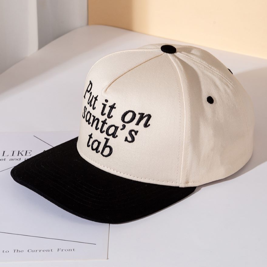 Add festive humor to your look with the Put It on Santa’s Tab baseball cap, a playful embroidered hat perfect for holiday parties, casual outings, or gifting. A fun seasonal accessory that spreads cheer while keeping your style relaxed and trendy.