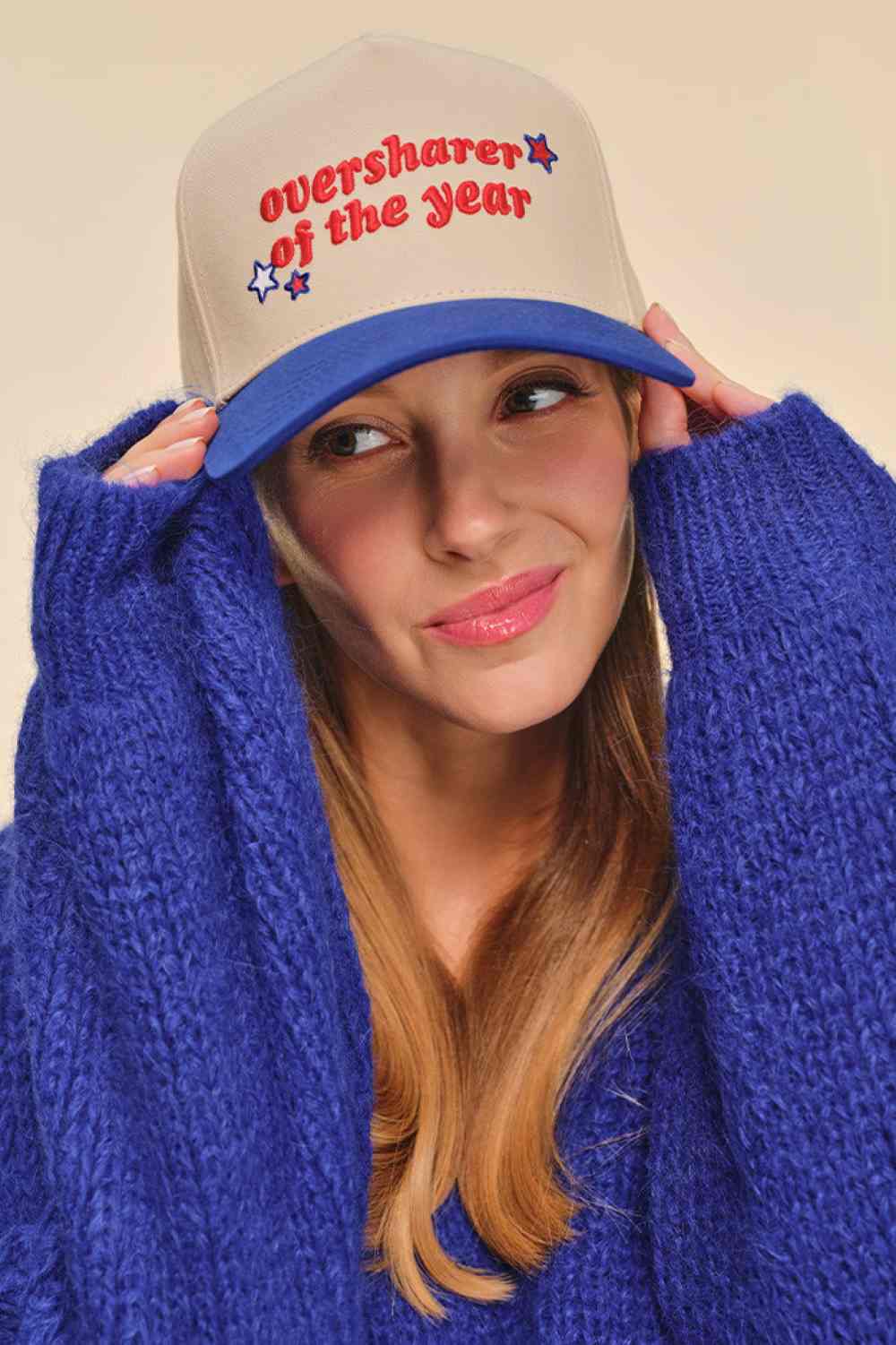 Blue Classic trucker style meets playful attitude with this C.C OVERSHARER OF THE YEAR snapback cap. Crafted from 100% cotton for breathable comfort, this two-tone baseball cap features embroidered lettering and star details that make a statement. The adjustable snap back closure fits one size, with a 22.5" circumference for a secure, comfortable fit. Perfect for casual wear or adding personality to any outfit. 
