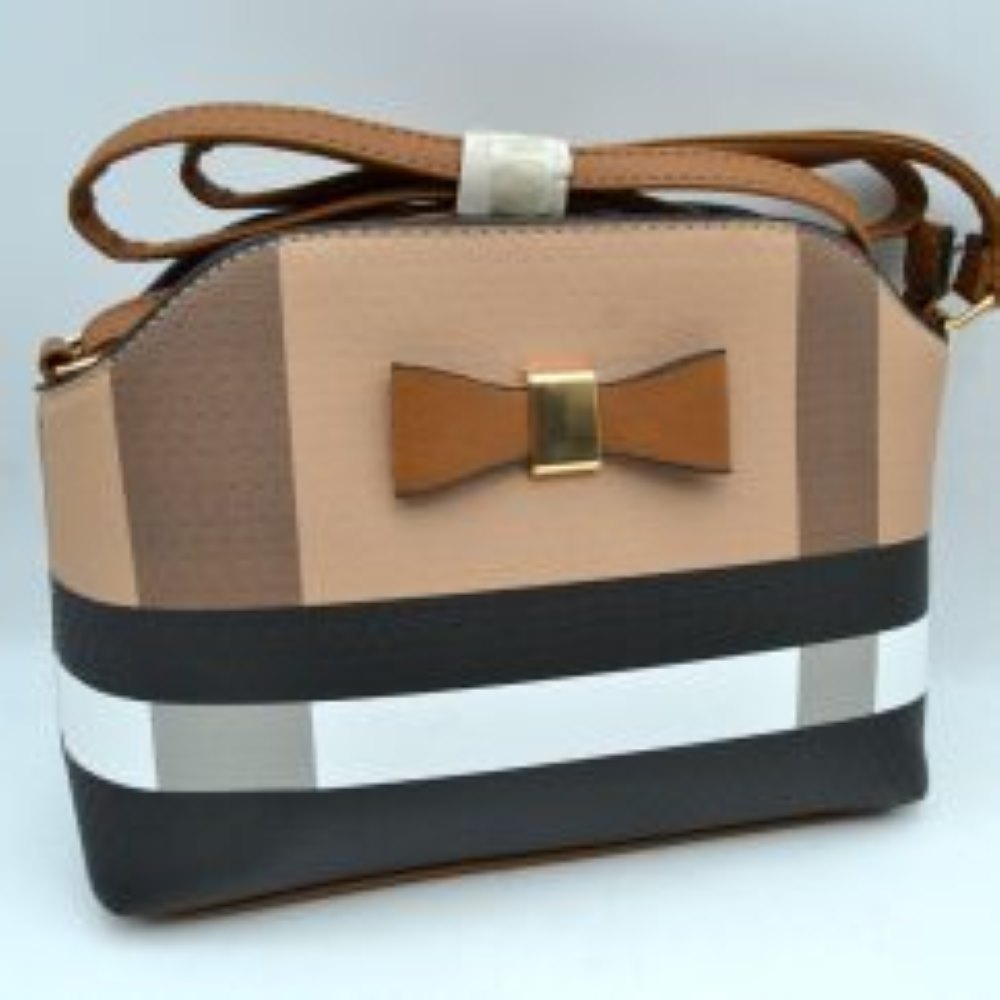 Brown This structured everyday handbag features a distinctive plaid pattern with contrasting vertical and horizontal stripes for a classic, tailored look. The compact design includes a main storage compartment along the curved top edge to securely hold your daily essentials. A stylized bow accent with a metallic center hardware piece highlights the front panel, while a long, adjustable shoulder strap provides versatile carrying options for hands-free convenience.