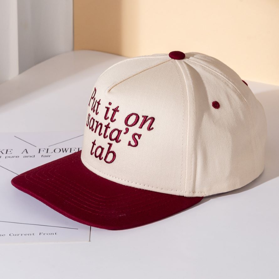 Add festive humor to your look with the Put It on Santa’s Tab baseball cap, a playful embroidered hat perfect for holiday parties, casual outings, or gifting. A fun seasonal accessory that spreads cheer while keeping your style relaxed and trendy.