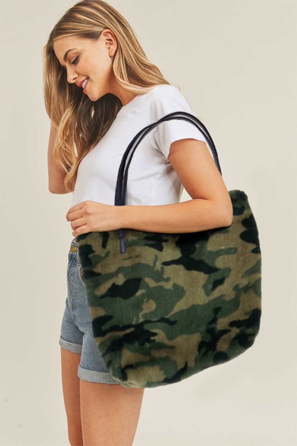 Camo Carry your essentials in style with this Camo Zipper Tote Bag. Featuring a classic camouflage pattern, this spacious 18" x 15" bag is perfect for everyday use, travel, or shopping. Crafted from durable 100% polyester, it's lightweight yet sturdy enough to handle daily wear. The secure zipper closure keeps your belongings safe and organized.