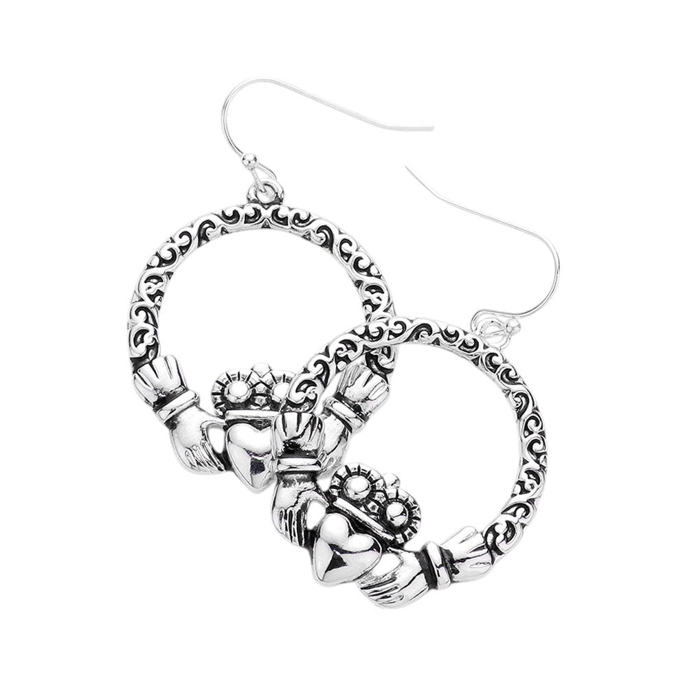 Claddagh Accented Open Metal Circle Dangle Earrings are a beautiful accessory that combines the traditional Irish Claddagh design with a modern open metal circle. These earrings are a unique and stylish addition to any jewelry collection. Made with high-quality materials, these earrings are both durable and elegant. Perfect for any occasion, these earrings will add a touch of sophistication to any outfit.