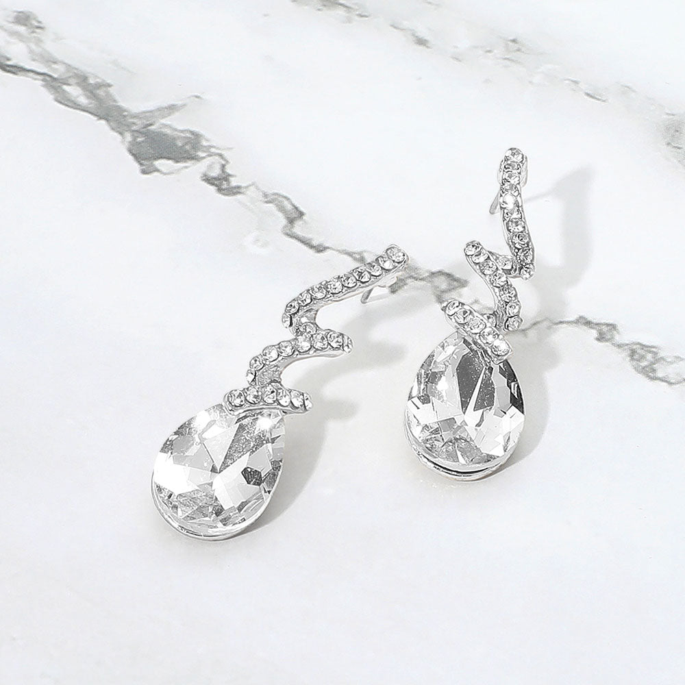 Madeline Love Clear, Silver Teardrop Glass Stone Drop Stone Paved Swirl Evening Earrings