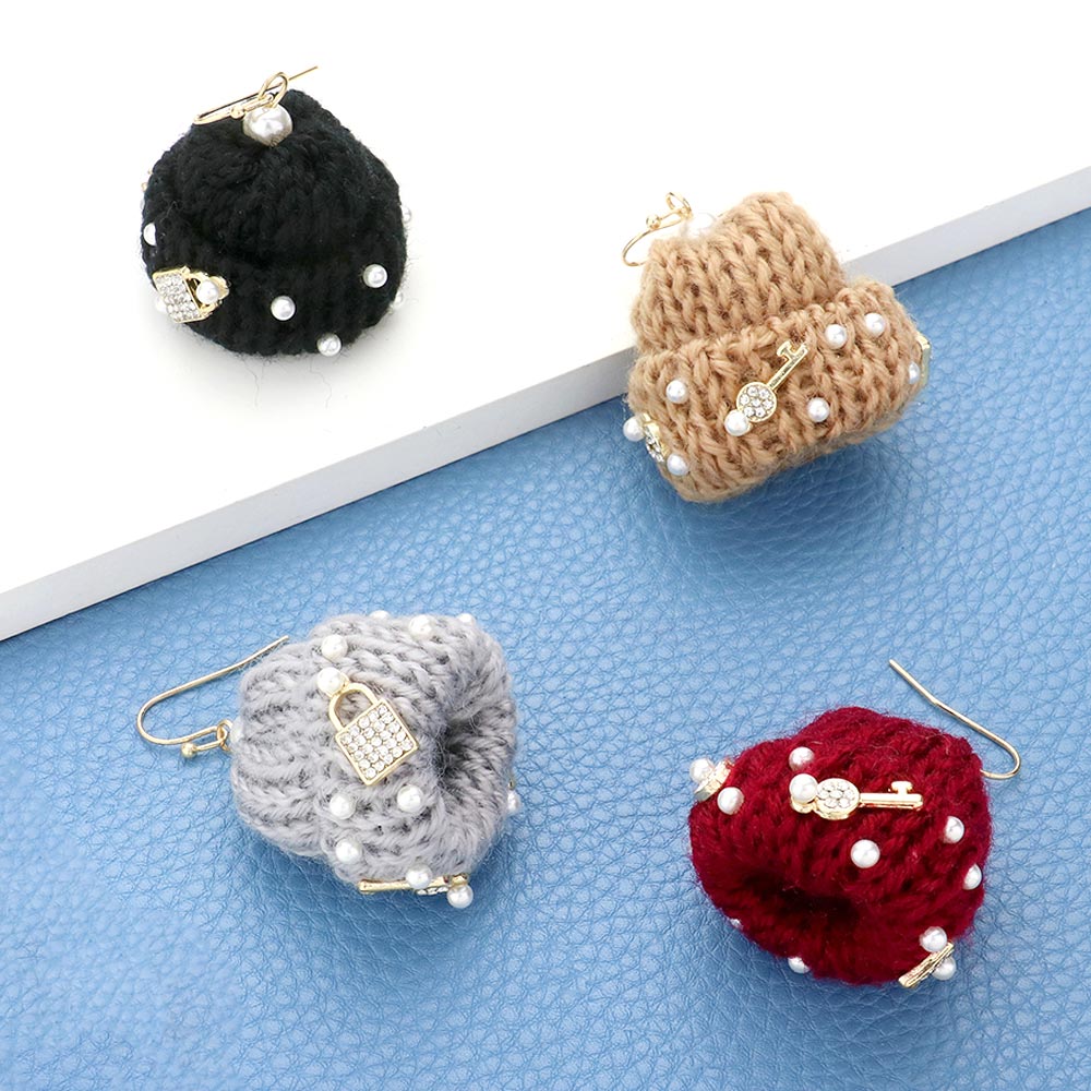 Pearl Key Lock Embellished Knit Beanie Hat Dangle Earrings add a touch of sophistication to any outfit. The pearl and key lock embellishments provide a unique and trendy twist, perfect for any fashion-forward individual. Stay warm and stylish with these versatile earrings.