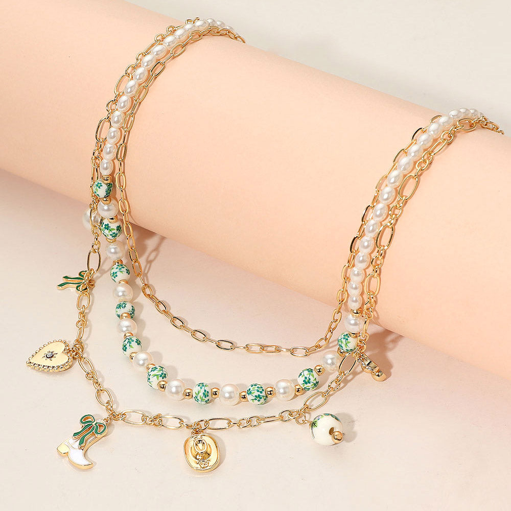 Madeline Love Gold, Green Western Cowboy Boot Hat Bow Cherry Heart Charm Station Pearl Floral Ceramic Ball Beaded Layered Necklace