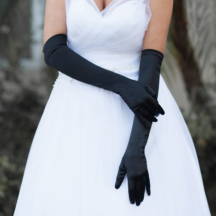 Black Dressy Satin Long Wedding Gloves feature a smooth, lustrous finish that adds timeless elegance to bridal and formal ensembles. Designed for a comfortable long fit, they provide a polished look while allowing ease of movement throughout your special occasion.