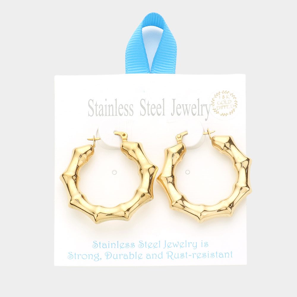 Gold 18K Gold Dipped Stainless Steel 1.5 Inch Metal Bamboo Hoop Earrings are expertly crafted using high-quality materials to provide a luxurious and durable accessory. The gold dipping process ensures a glossy finish and the 1.5-inch diameter adds a touch of elegance to any outfit.