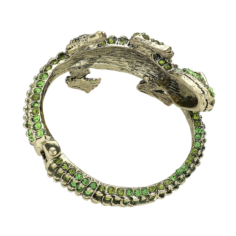 Gold Green Crystal Rhinestone Crocodile Alligator Hinged Cuff Bracelet is a dazzling accessory that adds a touch of glamour to any outfit. Its intricate design and sparkling rhinestones make it a standout piece, while its hinged cuff allows for a comfortable and secure fit. Elevate your style with this stunning bracelet.
