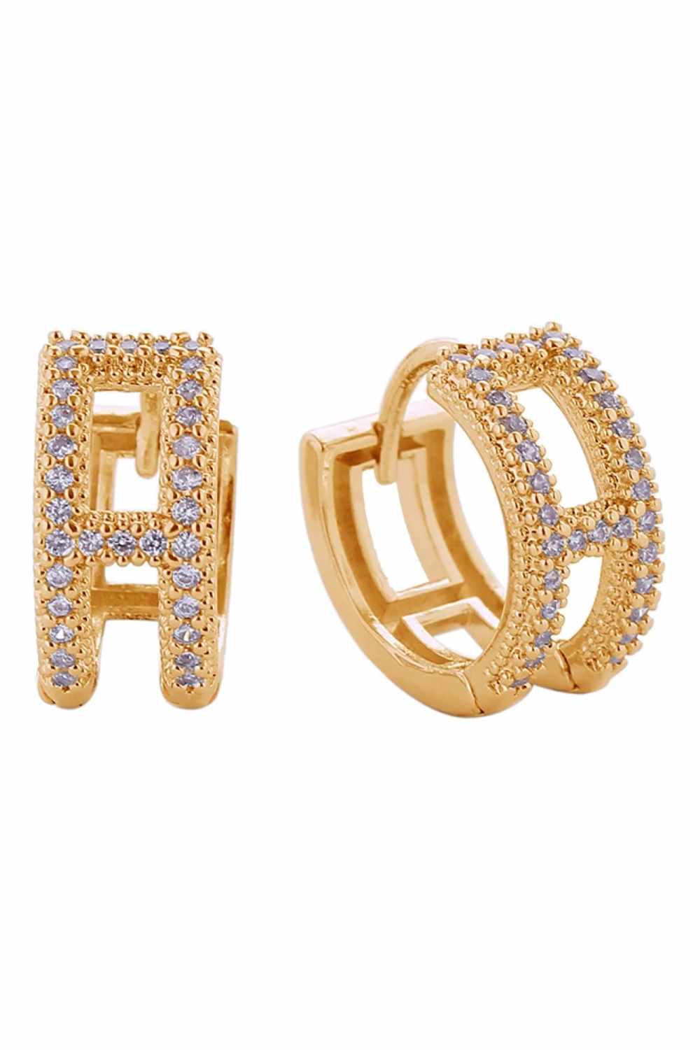 Gold Elegant huggie earrings featuring the initial H, crafted in brass with 14K gold or white gold dipping. Adorned with sparkling cubic zirconia pavé stones that catch the light beautifully. These hypoallergenic earrings are lead and nickel compliant, making them safe for sensitive ears. With a delicate 1.3cm diameter, they offer a subtle yet sophisticated look perfect for everyday wear or special occasions. Expertly made in Korea, these timeless pieces combine quality craftsmanship with modern style.