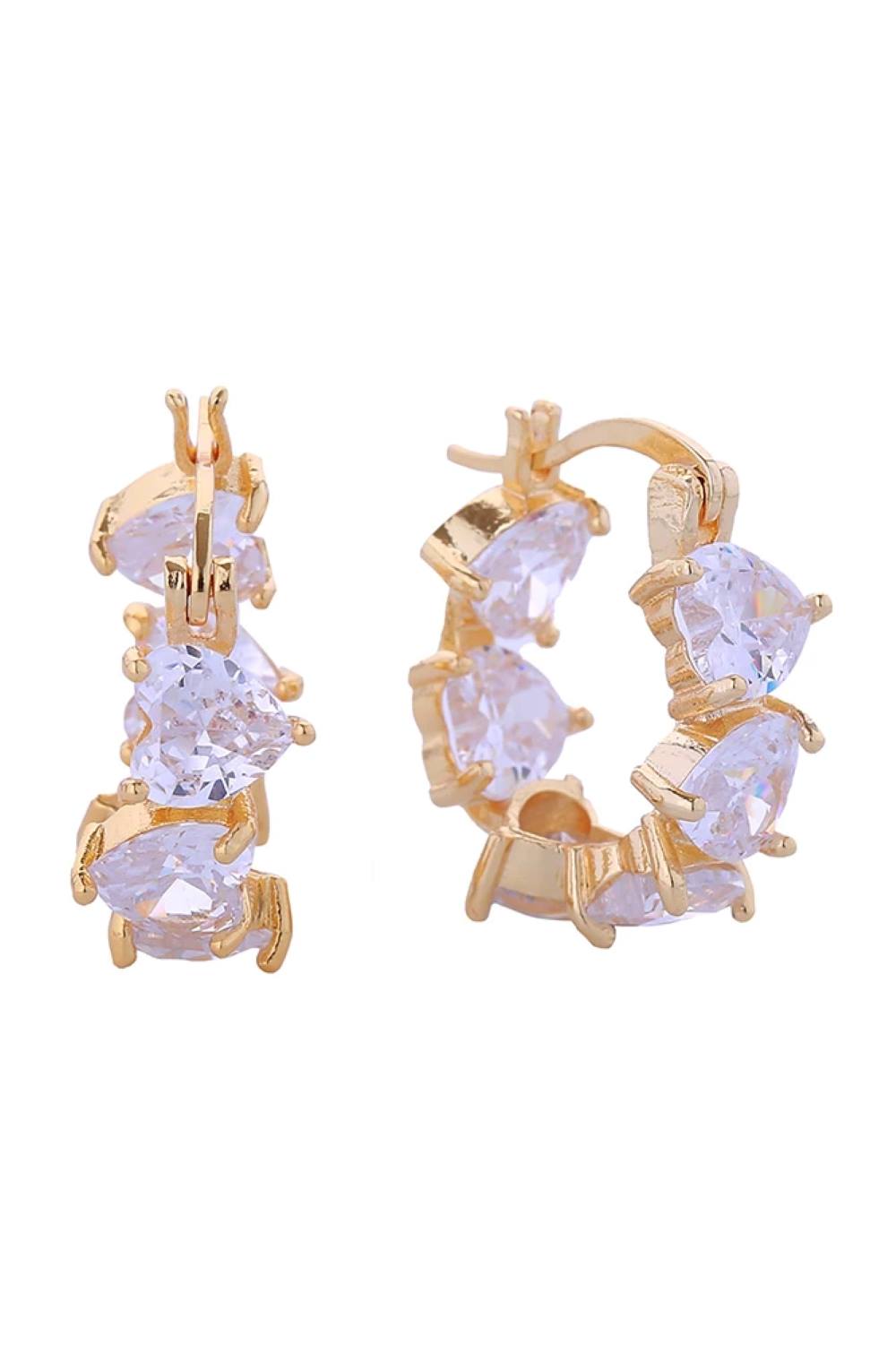 Gold Elegant post earrings featuring a delicate mingle heart design adorned with sparkling cubic zirconia pavé detailing. Crafted from brass with 14K gold and white dipping for a luxurious two-tone finish. Each earring measures 1.9cm in diameter, offering a refined yet noticeable presence. Hypoallergenic construction ensures comfortable all-day wear, while lead and nickel compliance guarantees safety and peace of mind. Perfect for everyday elegance or special occasions.
