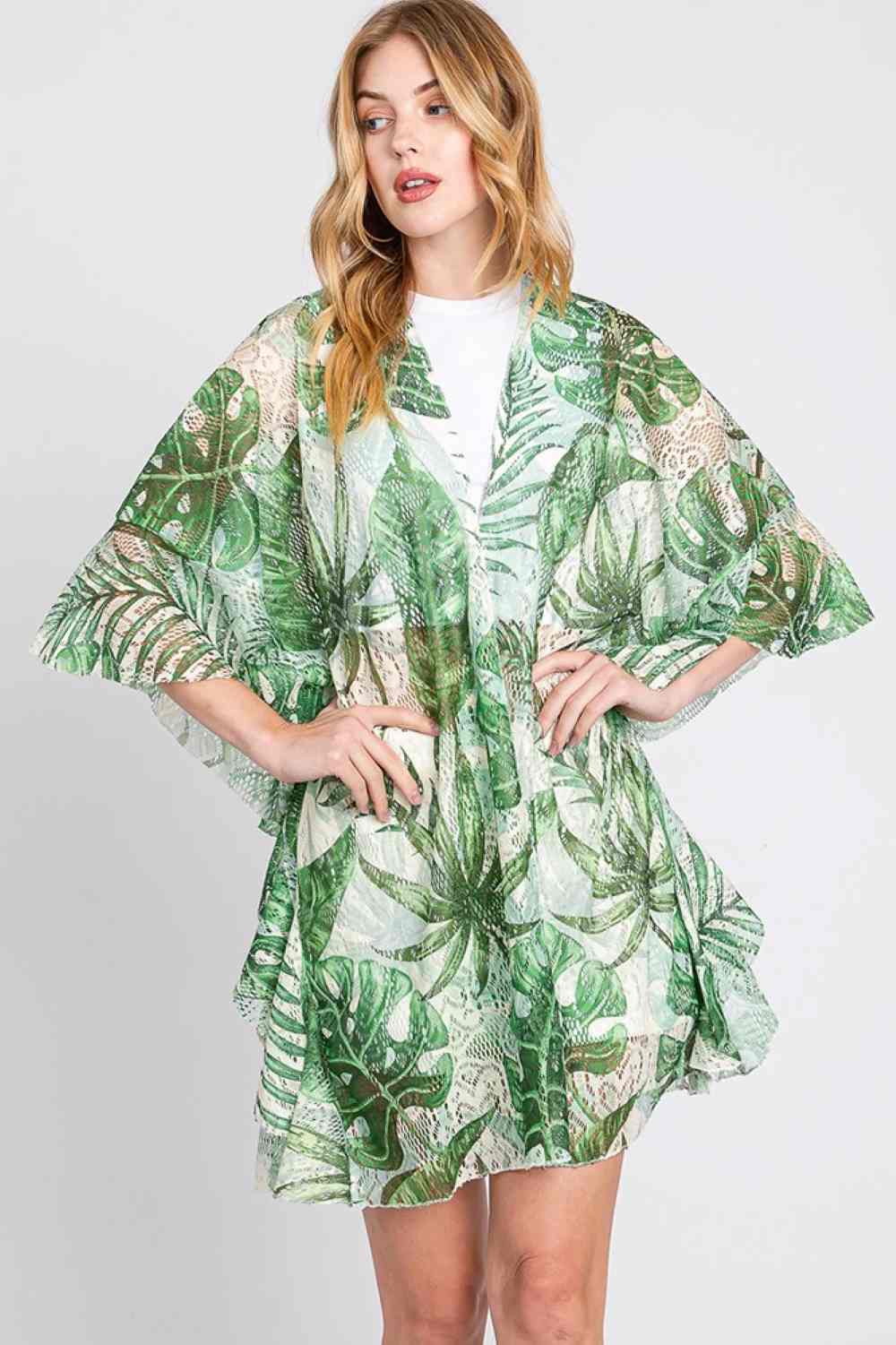 Green Effortless beach style meets tropical charm with this open-front crochet cover up. Delicate tropical leaf patterns are framed by feminine ruffled lining, creating a flattering silhouette perfect for layering over swimwear. Crafted from lightweight 100% polyester, it's breathable and easy to care for. Generous dimensions (35" x 32.5") provide comfortable coverage. Ideal for resort getaways, beach days, or poolside relaxation.