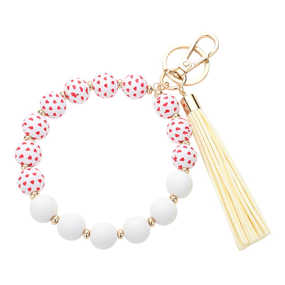 Ivory Heart Patterned Beaded Tassel Keychain Bracelet is a charming addition to your accessory collection. Handcrafted with intricate beadwork and a delicate heart pattern, it can be used as a keychain or stylish bracelet. Elevate your style while keeping your keys or wrist secure with this beautiful piece.