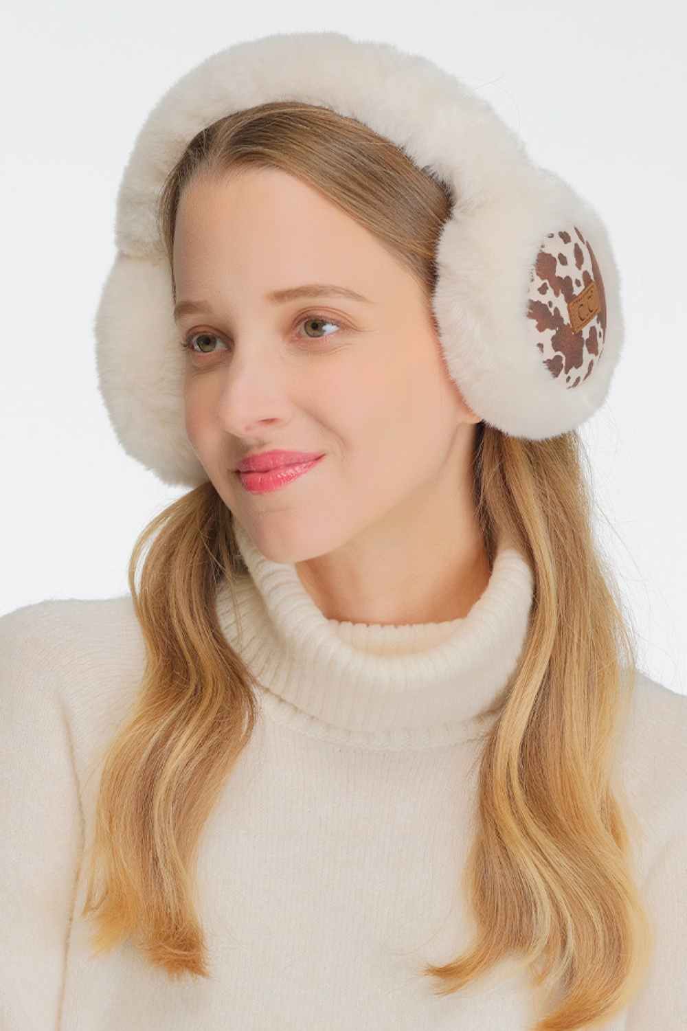 Ivory Stay warm and stylish with this cozy earmuff headband featuring a playful cow print design. Crafted from soft faux fur and suede-like polyester, it provides comfort during chilly weather. The adjustable band ensures a perfect fit for most head sizes, making it an easy grab-and-go accessory. Whether you're heading outdoors or running errands, this fun animal print ear warmer adds a touch of personality to any winter look.
