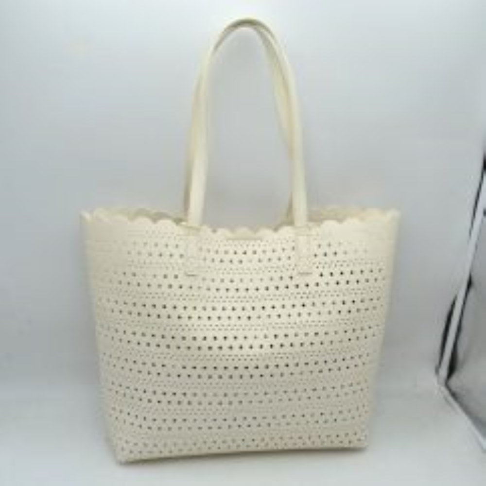 Ivory Bring an airy, classic look to your everyday style with this elegant perforated tote bag. Featuring an all-over laser-cut geometric pattern arranged in neat horizontal rows, this handbag stands out with its feminine, scalloped top border. The generously sized interior offers plenty of room to hold your daily essentials, electronics, or beach necessities, making it a perfect match for seasonal travel, market runs, or casual daytime outings.