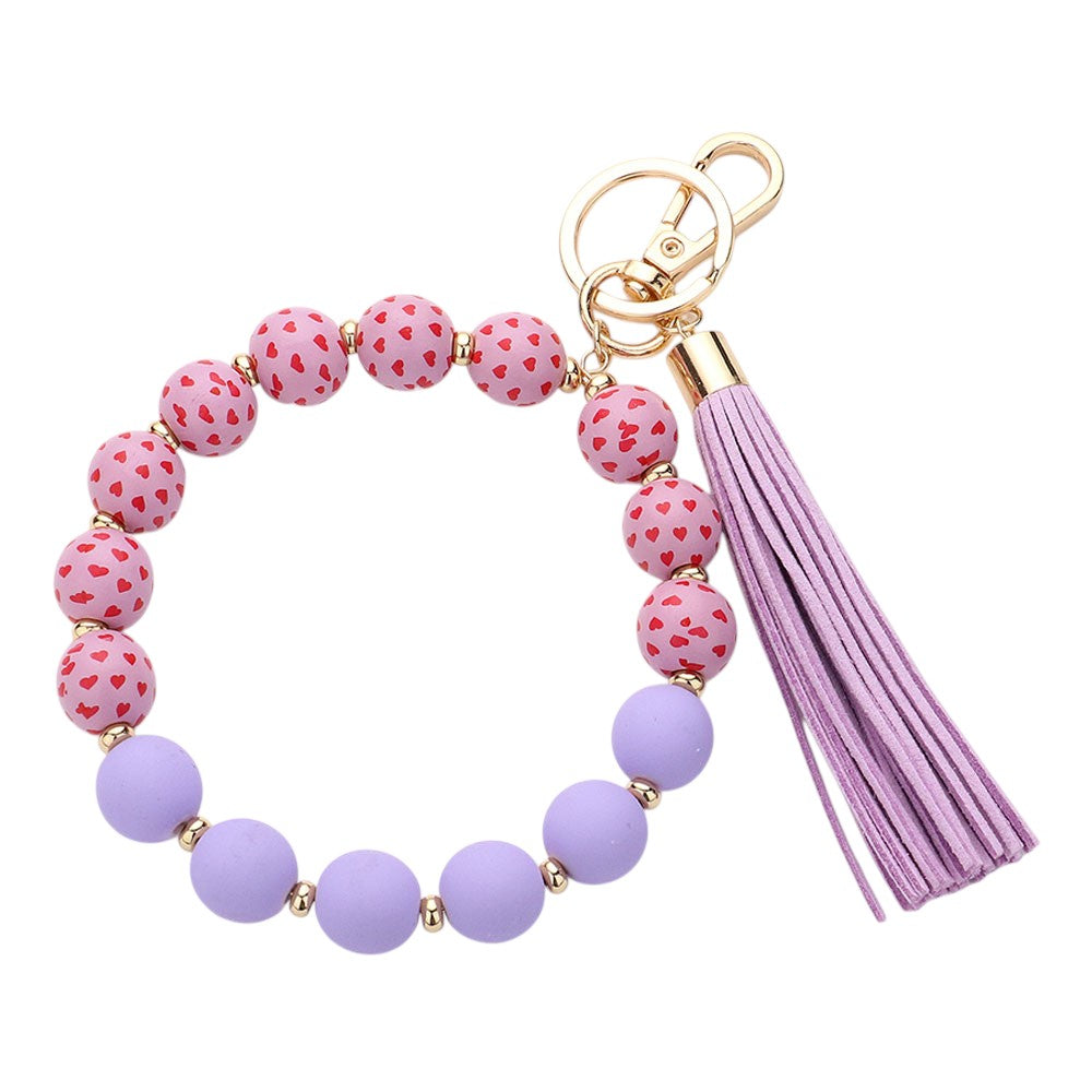 Lavender Heart Patterned Beaded Tassel Keychain Bracelet is a charming addition to your accessory collection. Handcrafted with intricate beadwork and a delicate heart pattern, it can be used as a keychain or stylish bracelet. Elevate your style while keeping your keys or wrist secure with this beautiful piece.