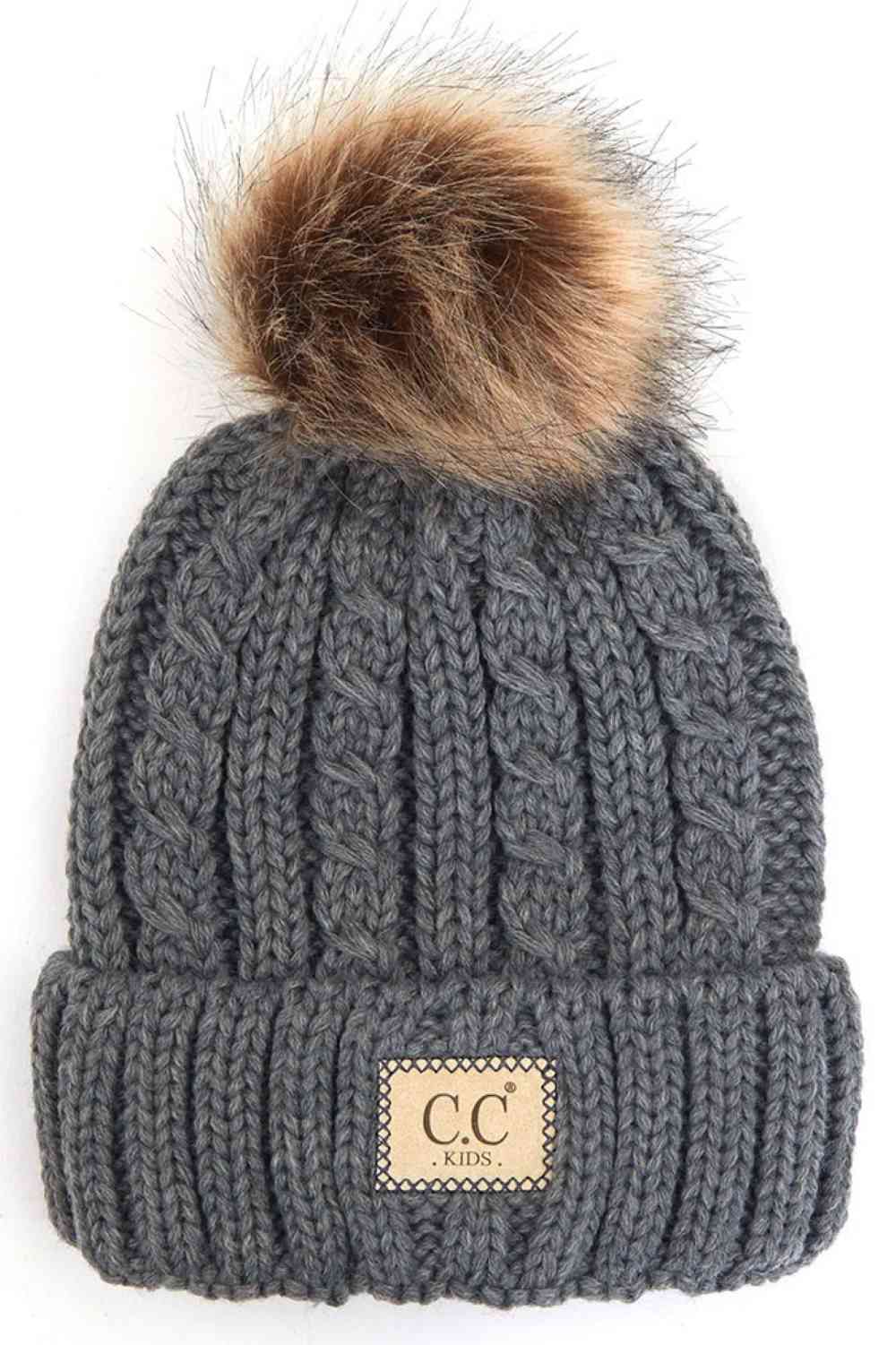 Light Gray Keep your little one cozy and cute with this C.C Kids Beanie featuring a ribbed knit design and natural faux fur pom. Made from 100% acrylic, it delivers soft warmth perfect for chilly days while the plush pom adds playful charm.