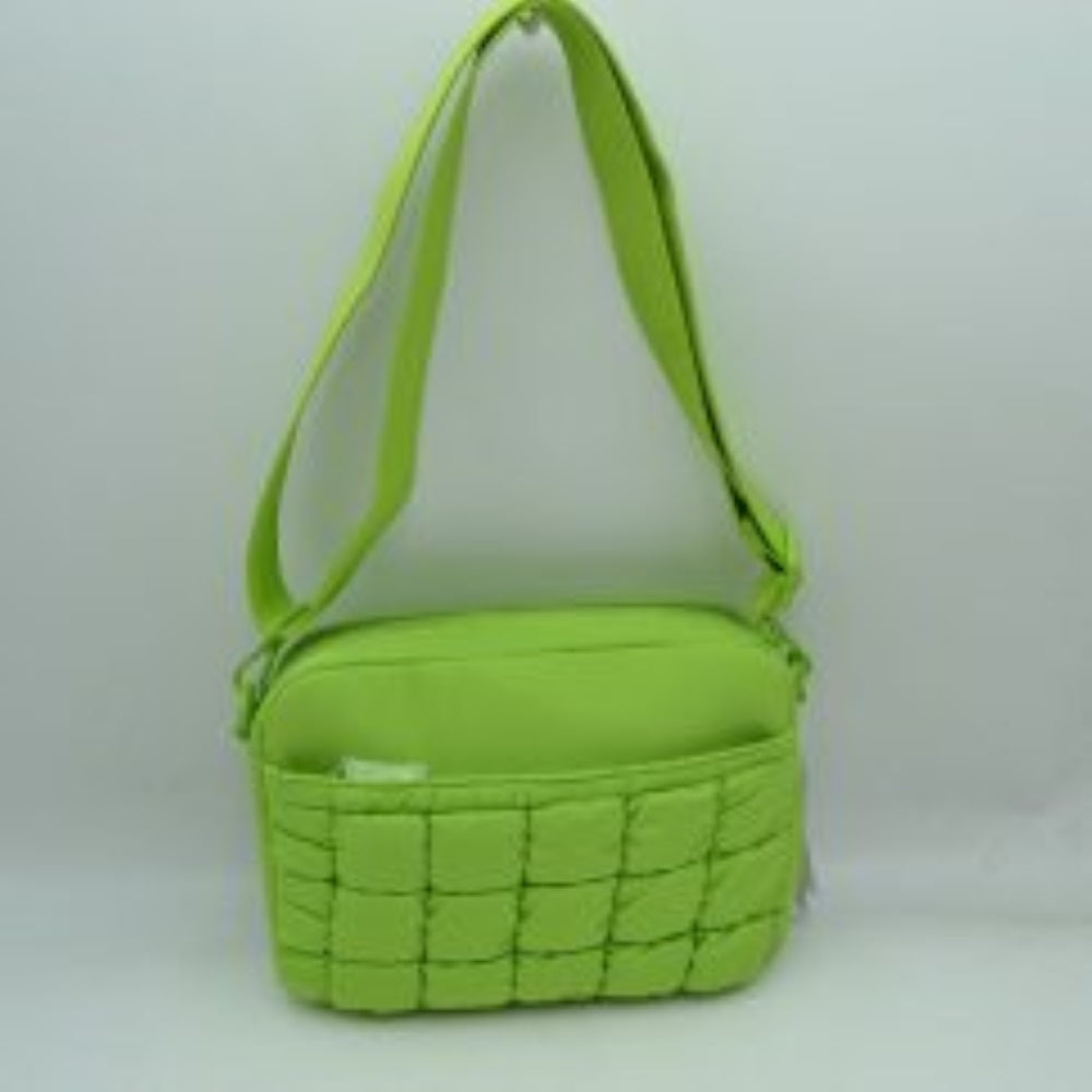 Lime This practical crossbody bag is designed for effortless everyday use, featuring a distinct quilted pattern across the lower front section. It offers multiple storage compartments, including a secure main zippered closure and an easily accessible front slip pocket to organize your daily essentials. A wide, adjustable shoulder strap ensures comfortable, customizable carrying, making it a perfect accessory for hands-free convenience while on the go.