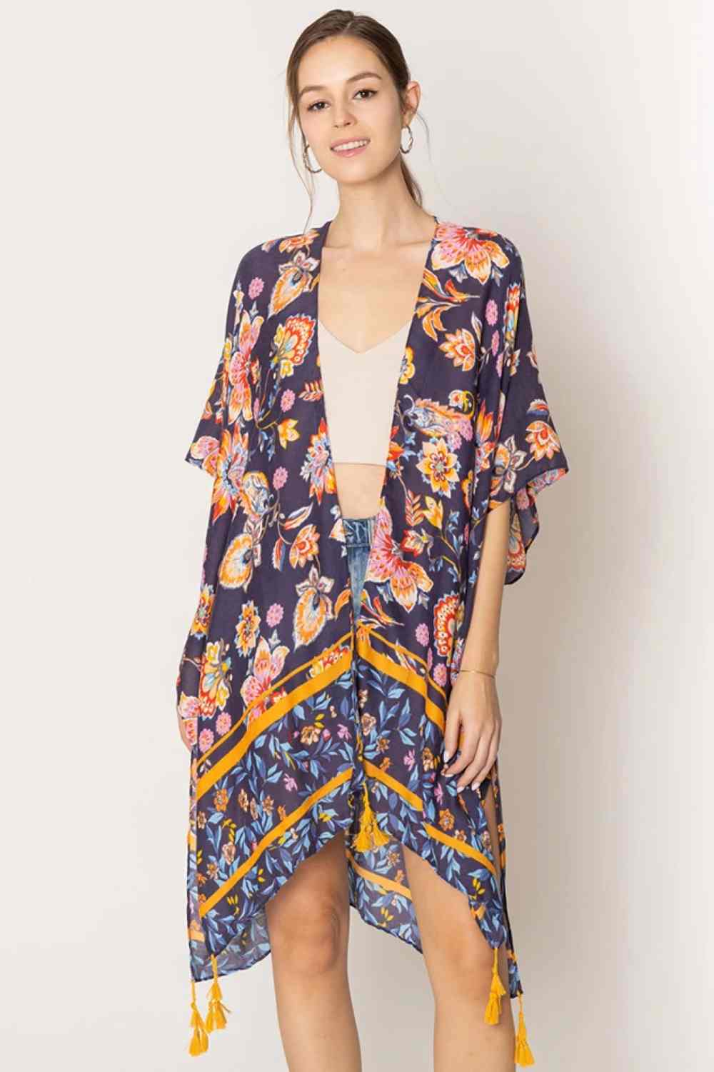 Navy Embrace effortless elegance with this stunning Floral Print Tassel Kimono. Crafted from lightweight 100% polyester, this versatile piece features a beautiful floral design and charming tassel details that add movement and dimension. With generous dimensions of 35.4" x 35.4", it drapes beautifully over any outfit, perfect for layering during warmer months or as a beach cover-up.