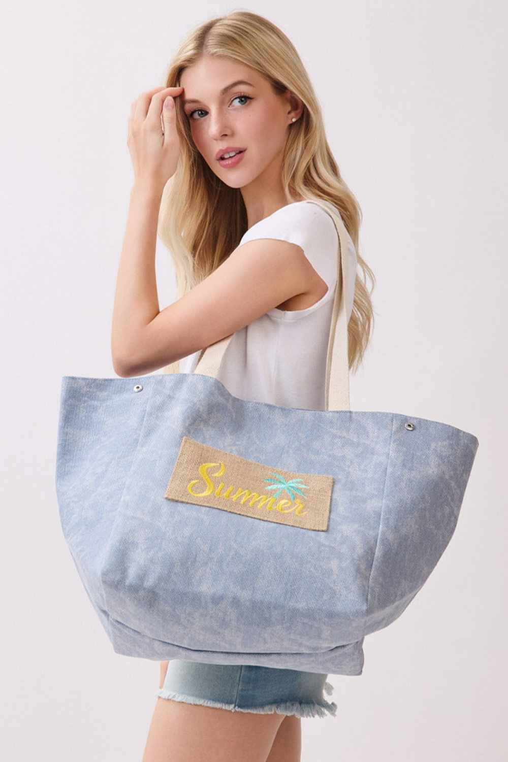 Navy Carry your summer essentials in style with this versatile shoulder and bucket tote. Crafted from a durable blend of 90% polyester and 10% burlap, this spacious bag features a bold SUMMER letter design that captures the season's carefree spirit. Measuring 22" x 13" x 9.5", it offers ample room for beach days, shopping trips, or everyday adventures. The magnetic snap closure keeps your belongings secure, while the convenient inner pocket provides organized storage for smaller items. Perfect for anyone se