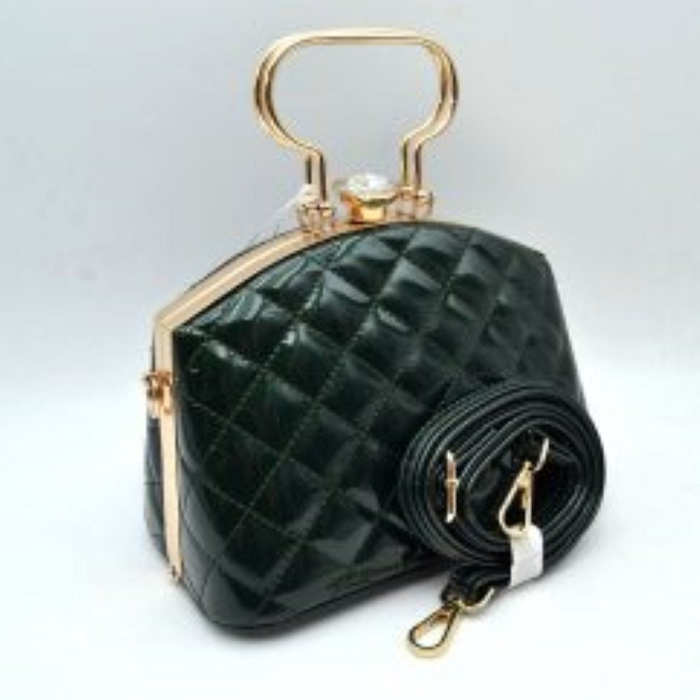 Olive This structured handbag features a glossy, quilted exterior pattern that adds texturing to its rigid silhouette for everyday use. It is styled with distinctive metallic top handles and a secure upper storage compartment accessible through a solid frame opening. An ornamental crystal-like clasp sits prominently at the top closure, while side hardware rings accommodate the included matching detachable shoulder strap with metallic clips for multi-way wear.