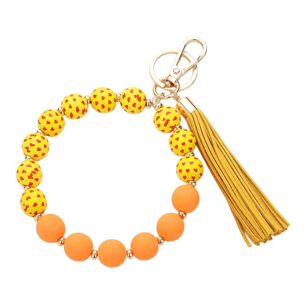Orange Yellow Heart Patterned Beaded Tassel Keychain Bracelet is a charming addition to your accessory collection. Handcrafted with intricate beadwork and a delicate heart pattern, it can be used as a keychain or stylish bracelet. Elevate your style while keeping your keys or wrist secure with this beautiful piece.
