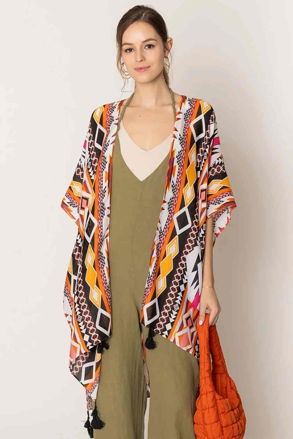 Orange Embrace bohemian style with this striking Aztec Print Tassel Kimono. Featuring bold geometric patterns inspired by traditional Aztec designs, this lightweight piece drapes beautifully over any outfit. The decorative tassels add movement and texture, while the generous 35.4" x 35.4" dimensions provide versatile layering options. Crafted from soft, breathable 100% polyester, it's perfect for beach days, casual outings, or adding an artistic touch to your wardrobe.