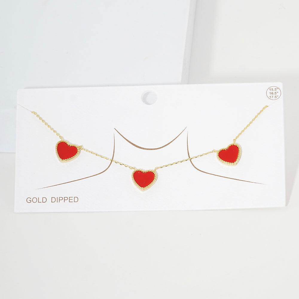 Red Gold Dipped Triple Heart Pendant Necklace adds a touch of romance to any outfit. Crafted with quality and precision, each heart is dipped in genuine gold for a luxurious finish. This necklace is a stunning addition to any jewelry collection, perfect for special occasions or everyday wear.