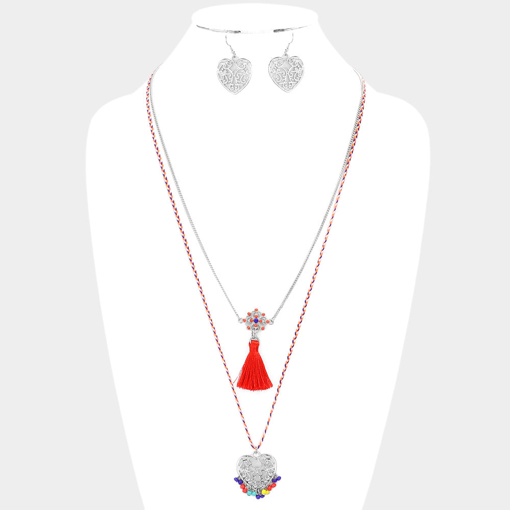 Heart Pendant Necklace with Tassel features a beautiful tassel design, making it a unique and stylish addition to any outfit. Crafted with expert precision, this necklace is sure to make a statement. Handmade with care, it symbolizes love and will be cherished for years to come.