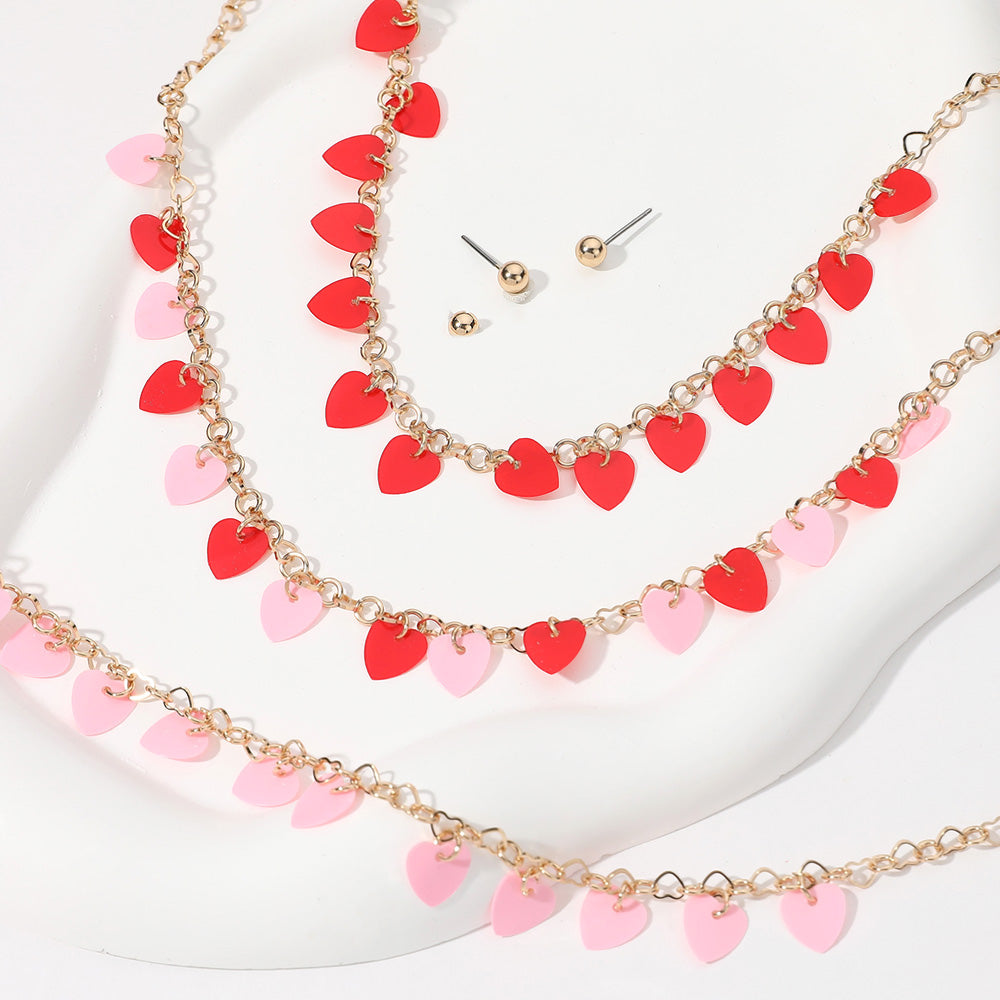 Pink-Heart Sequin Station Jewelry Set is the perfect accessory for any outfit. Crafted with precision and featuring delicate heart-shaped sequins, this necklace is both elegant and fun. Add a touch of sparkle and charm to your ensemble with this eye-catching necklace.