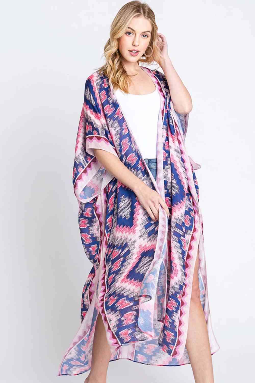 Pink Embrace bohemian elegance with this Aztec Print Open Front Long Kimono. Featuring a striking geometric pattern inspired by traditional Aztec designs, this lightweight piece drapes beautifully over any outfit. The open front silhouette offers effortless layering versatility, while the generous 35" x 47.5" dimensions provide comfortable coverage. Crafted from 100% polyester for easy care and durability. Perfect for adding texture and cultural flair to your everyday wardrobe or beach getaway.