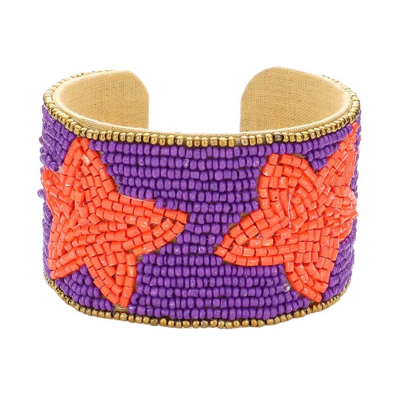 Purple Orange This Game Day Beaded Star Accented Cuff Bracelet adds a stylish touch to any ensemble. The beaded star accents on the cuff give it a unique, eye-catching design, perfect for game day or any day. Wear it to show your support for your favorite team - you're sure to stand out from the crowd.