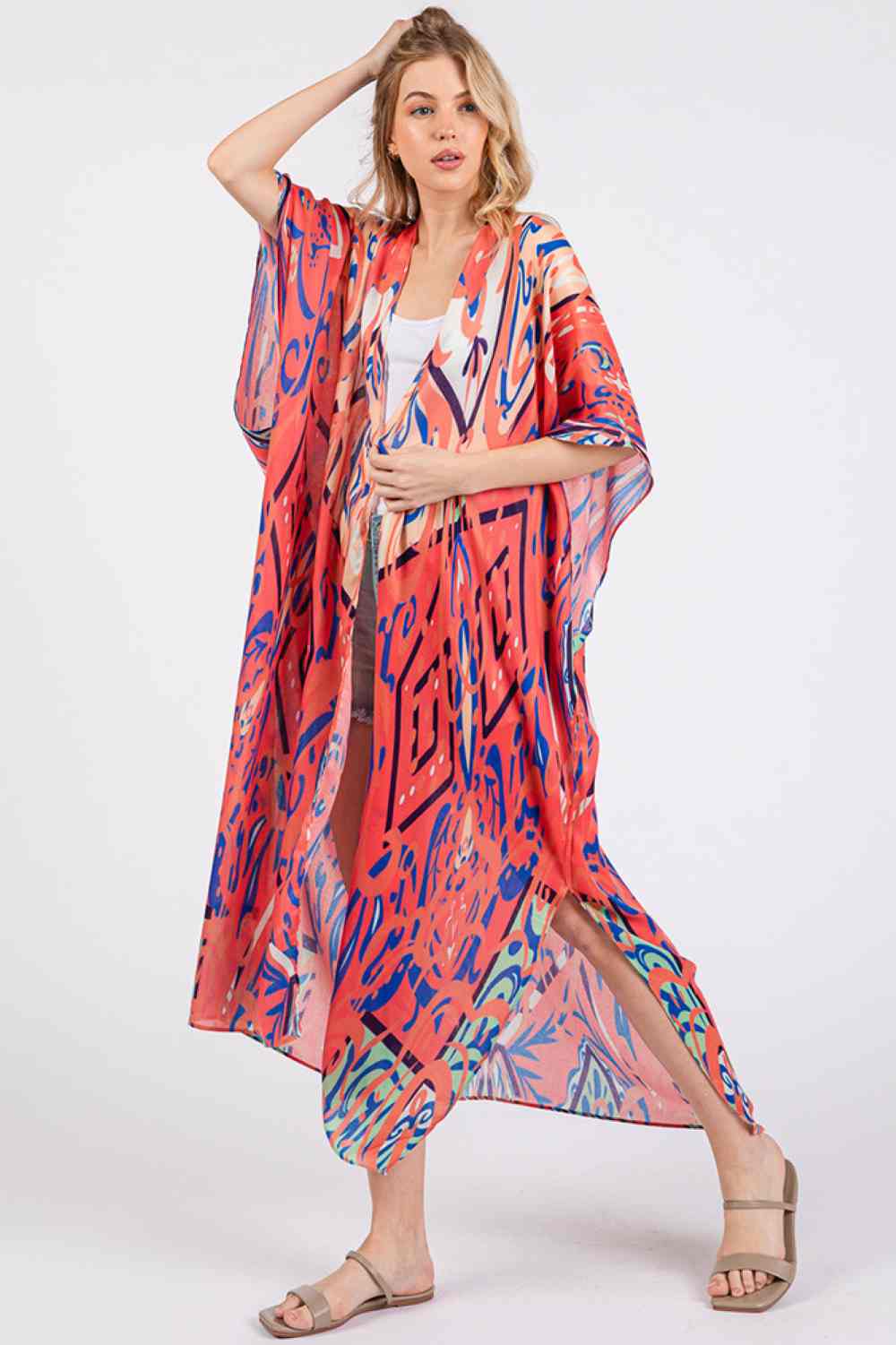 Red Effortless bohemian elegance meets summer comfort in this open-front kimono cover-up. Crafted from lightweight 100% polyester, it drapes beautifully over swimwear or casual outfits with its relaxed, flowing silhouette. The boho-inspired print adds artistic flair to any beach day or resort look. Generously sized at 35" x 47.5", it offers easy layering and movement. Perfect for poolside, beach getaways, or breezy warm-weather styling.