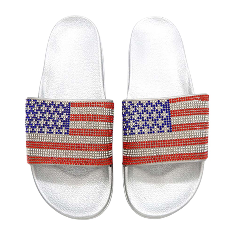 Silver Bling American USA Flag Slide Sandal Slippers are the perfect way to show off your patriotic style. The stunning design features a shimmering American flag, making them a fun and stylish addition to any summer outfit. With a comfortable fit and durable construction, these slippers are a must-have for any proud American.