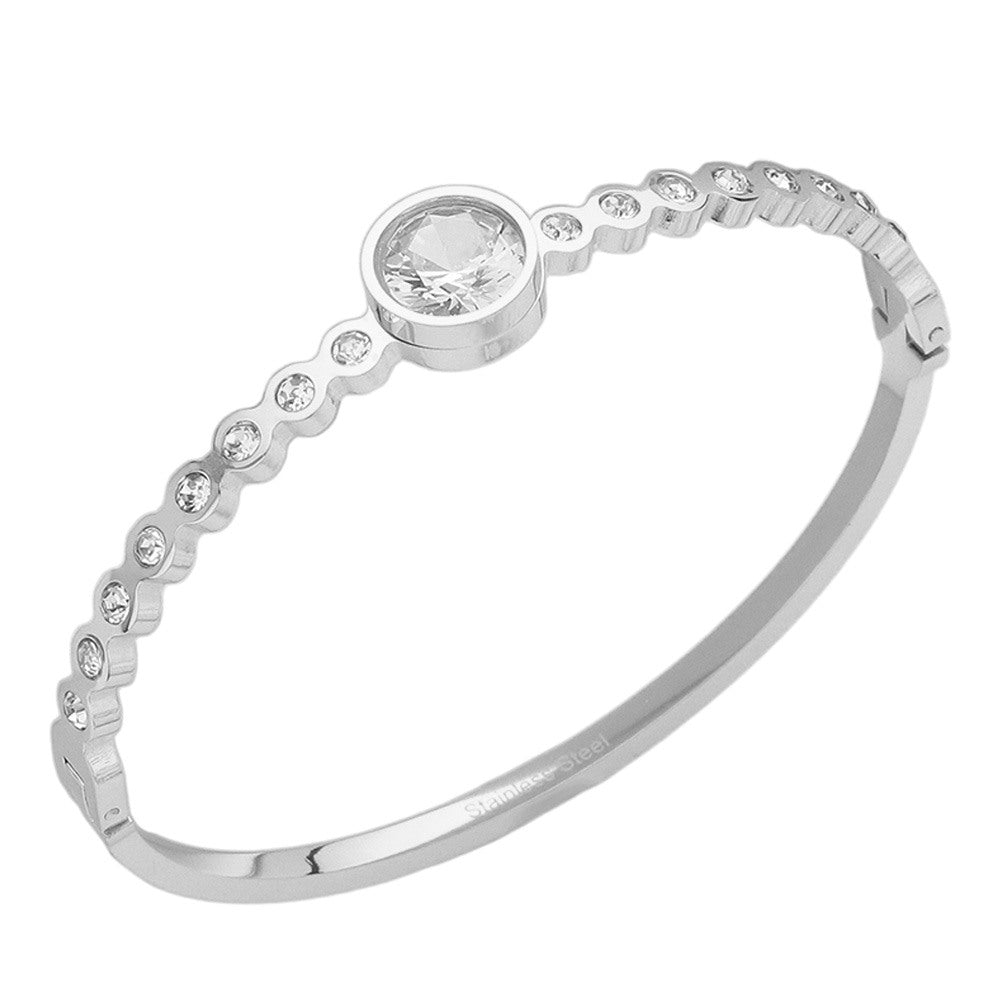 Silver Stainless Steel Round CZ Stone Bezel Hinged Bangle Bracelet. Made with high-quality stainless steel and featuring beautifully cut CZ stones in a bezel setting, this bangle adds a touch of elegance to any outfit. With a hinged design, it is easy to put on and take off for a comfortable fit. Elevate your style with this sophisticated accessory.