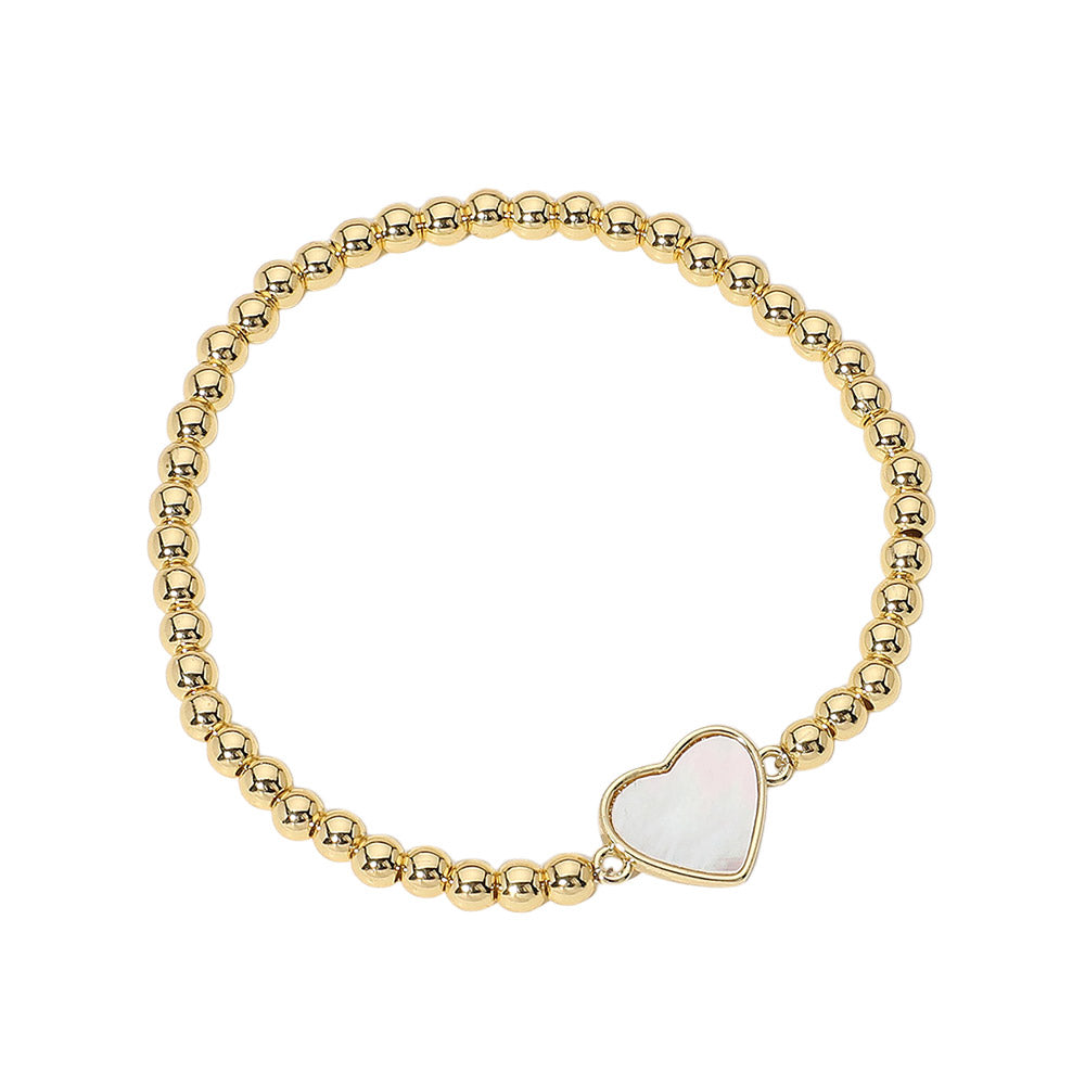 Gold Stainless Steel Ball Mother of Pearl Heart Beaded Bracelet is expertly crafted with durable stainless steel and accented with a shimmering mother-of-pearl heart. The stretch design ensures a comfortable fit, making it perfect for everyday wear. Add a touch of elegance to any outfit with this sophisticated accessory.