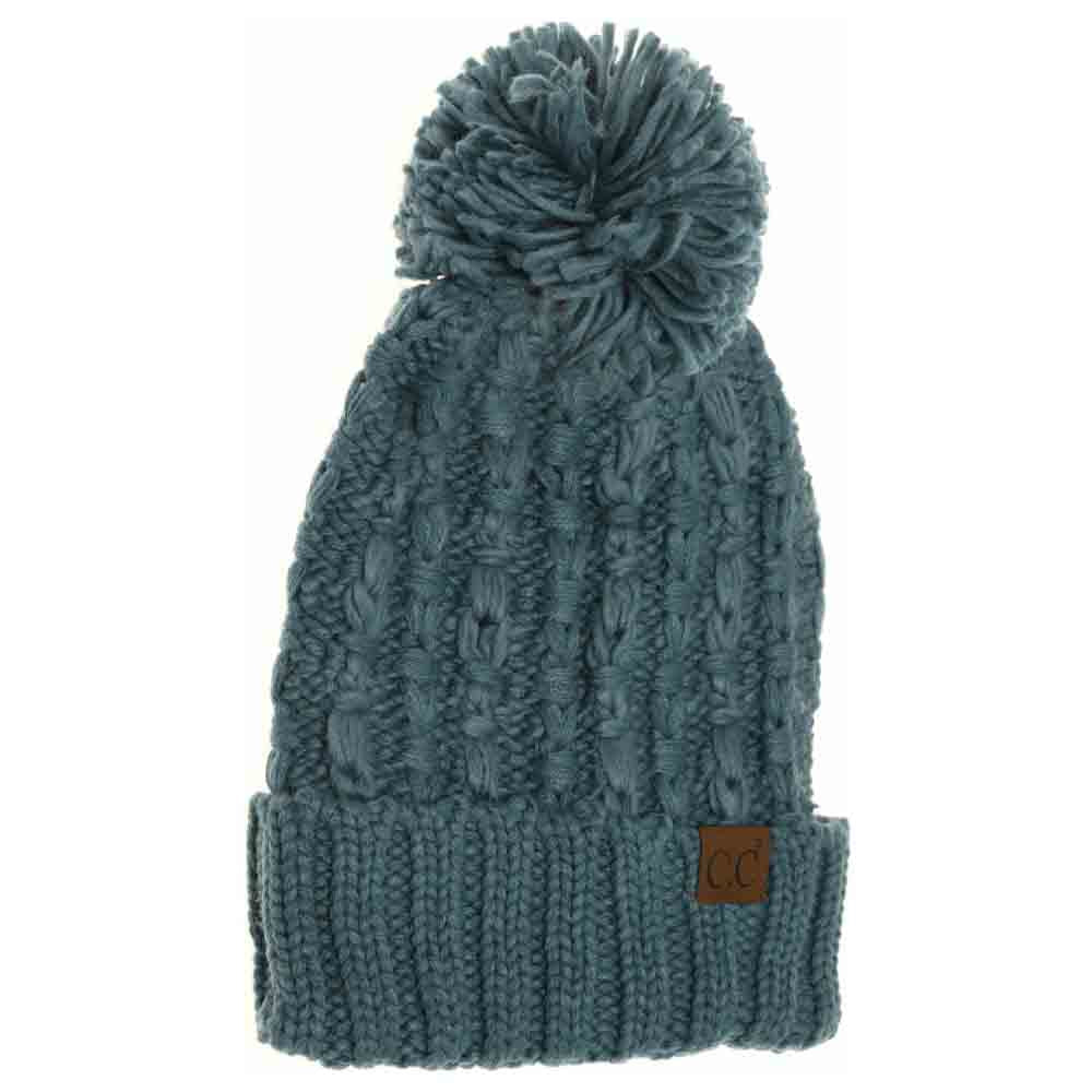 Steel-Blue- Slipstitch Pom Beanie expertly blends functional warmth with refined design. Crafted with a textured slipstitch knit, it ensures durability and a snug fit while maintaining breathability. The added pom offers a subtle yet distinctive accent, making this beanie an essential piece for both outdoor protection and polished winter style.