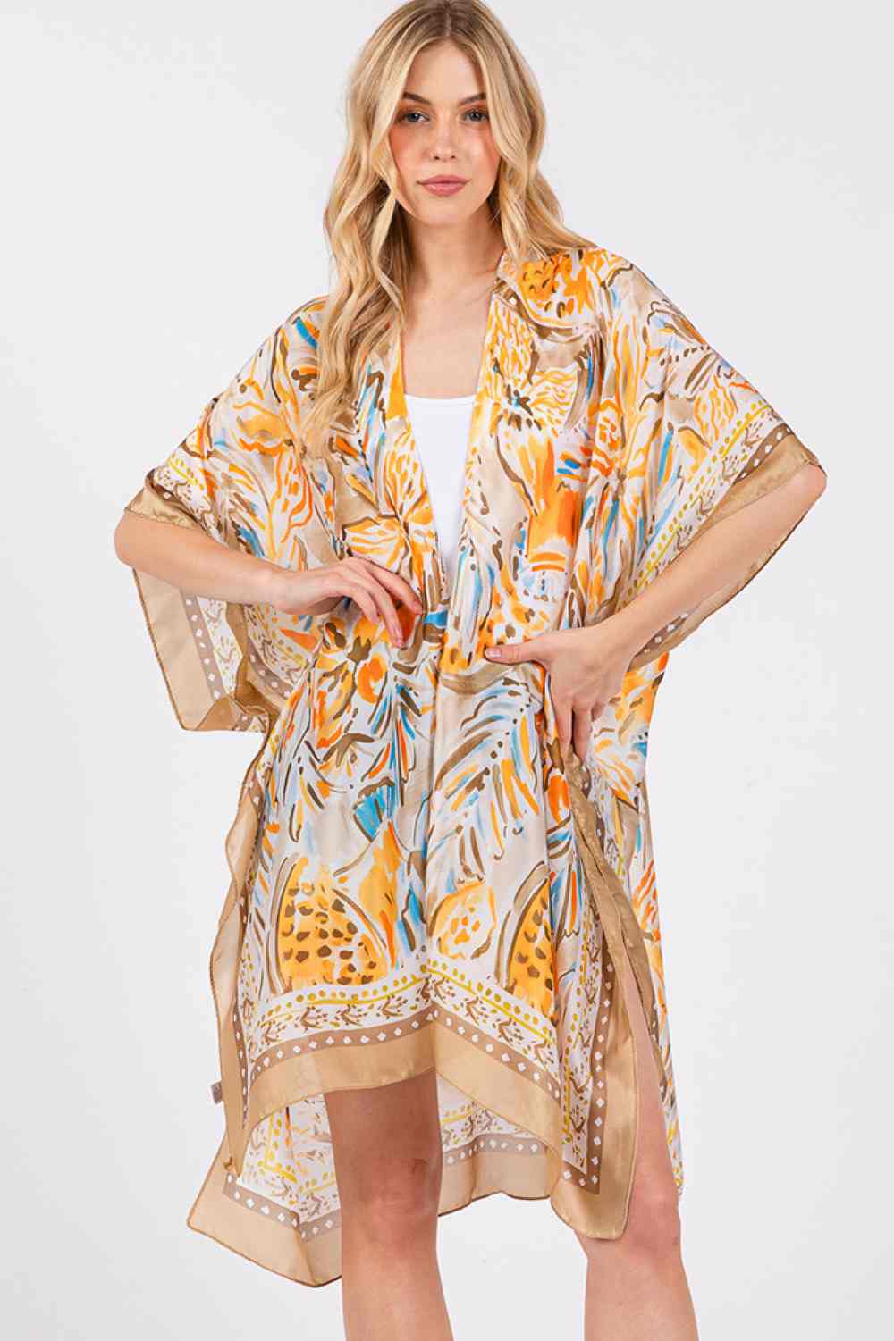 Taupe Embrace effortless summer style with this stunning floral kimono cover-up. Featuring a vibrant flower pattern and luxuriously silky feel, it's the perfect lightweight layer for beach days, poolside lounging, or casual outings. The generous 35" x 36" dimensions provide comfortable coverage and movement. Crafted from 100% polyester for easy care and durability. Slip it on over your favorite swimsuit or dress for an instant touch of elegance and sophistication.