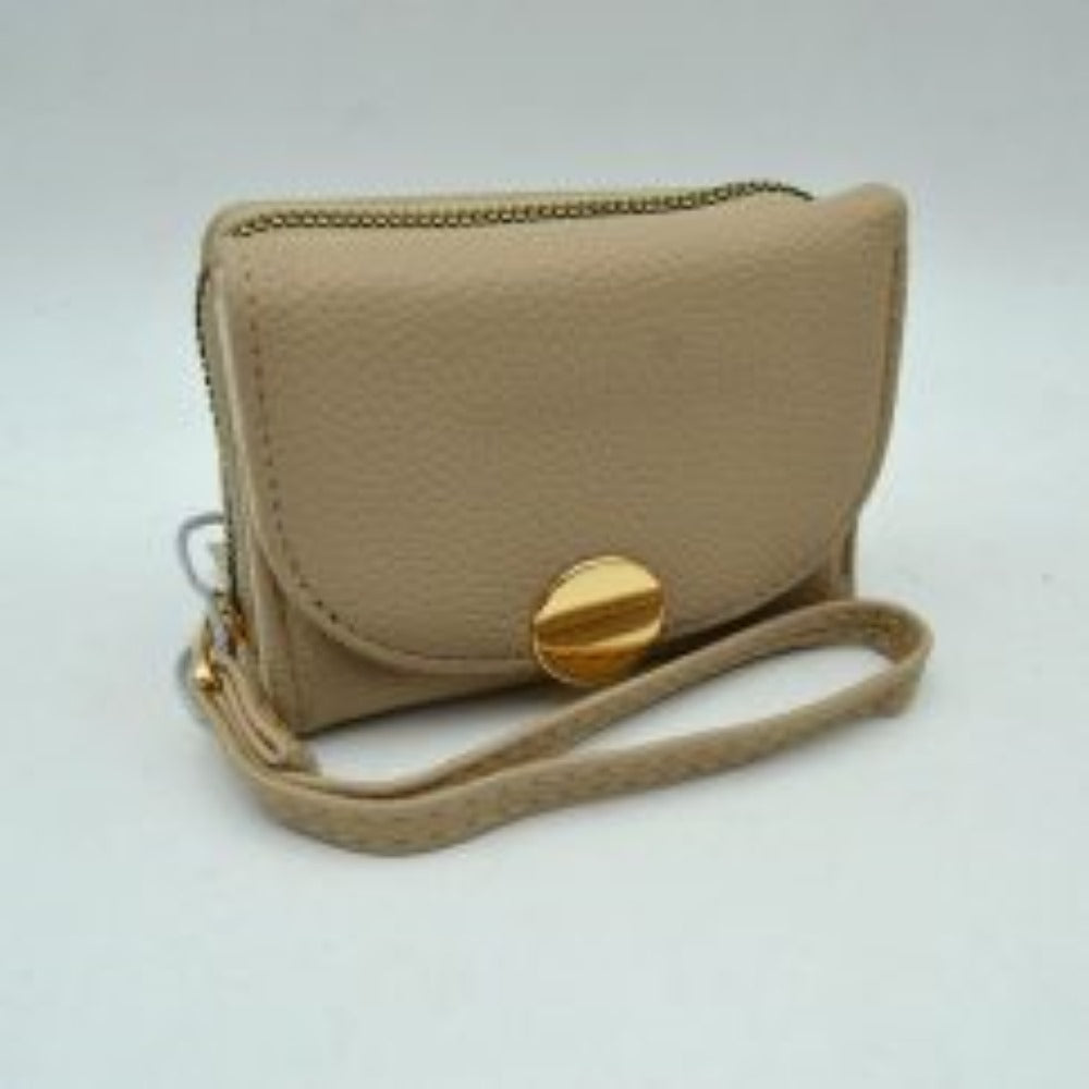 Taupe This compact everyday wallet features a pebbled, textured exterior designed for practical multi-compartment storage. It includes a secure, top zip-around section with metallic teeth alongside a front fold-over flap portion accented by a prominent round metallic button closure. For convenient carrying during daily errands, it comes equipped with a slim, matching wristlet strap attached to the side hardware.