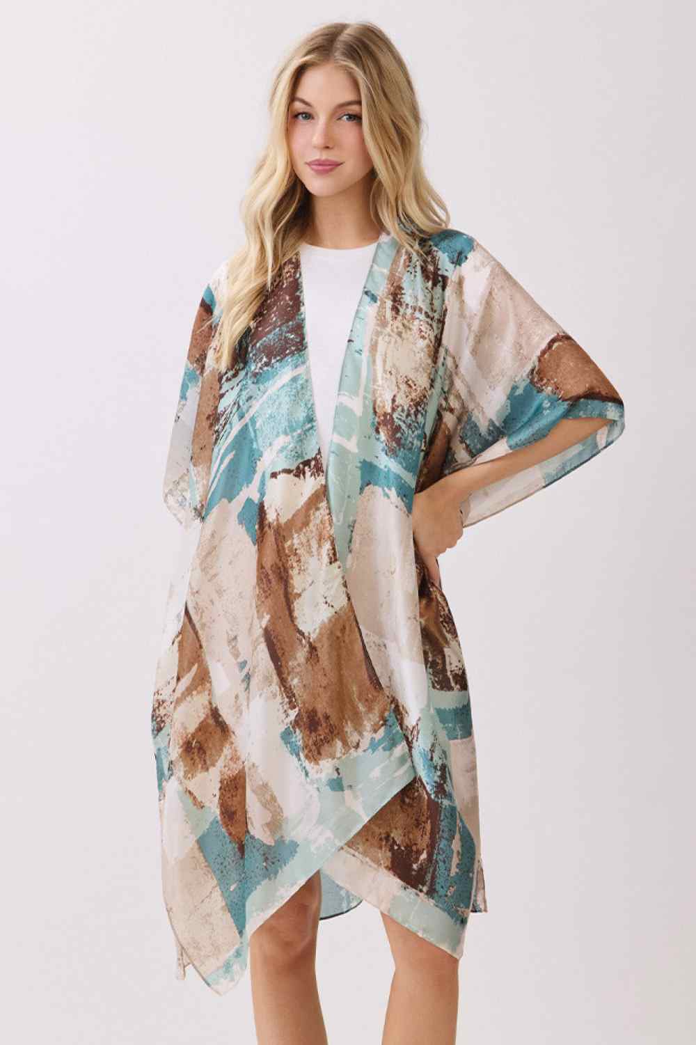 Teal Elevate your beach or resort wardrobe with this stunning Abstract Modern Art-Inspired Print Kimono. Crafted from 100% polyester with a luxuriously silky feel, this cover-up drapes beautifully over swimwear or casual outfits. The bold, contemporary print adds an artistic flair to any look, while the generous 35" x 36" dimensions provide comfortable coverage. Perfect for poolside lounging, beach days, or layering over your favorite pieces. Lightweight and easy to care for, this kimono is an effortless wa