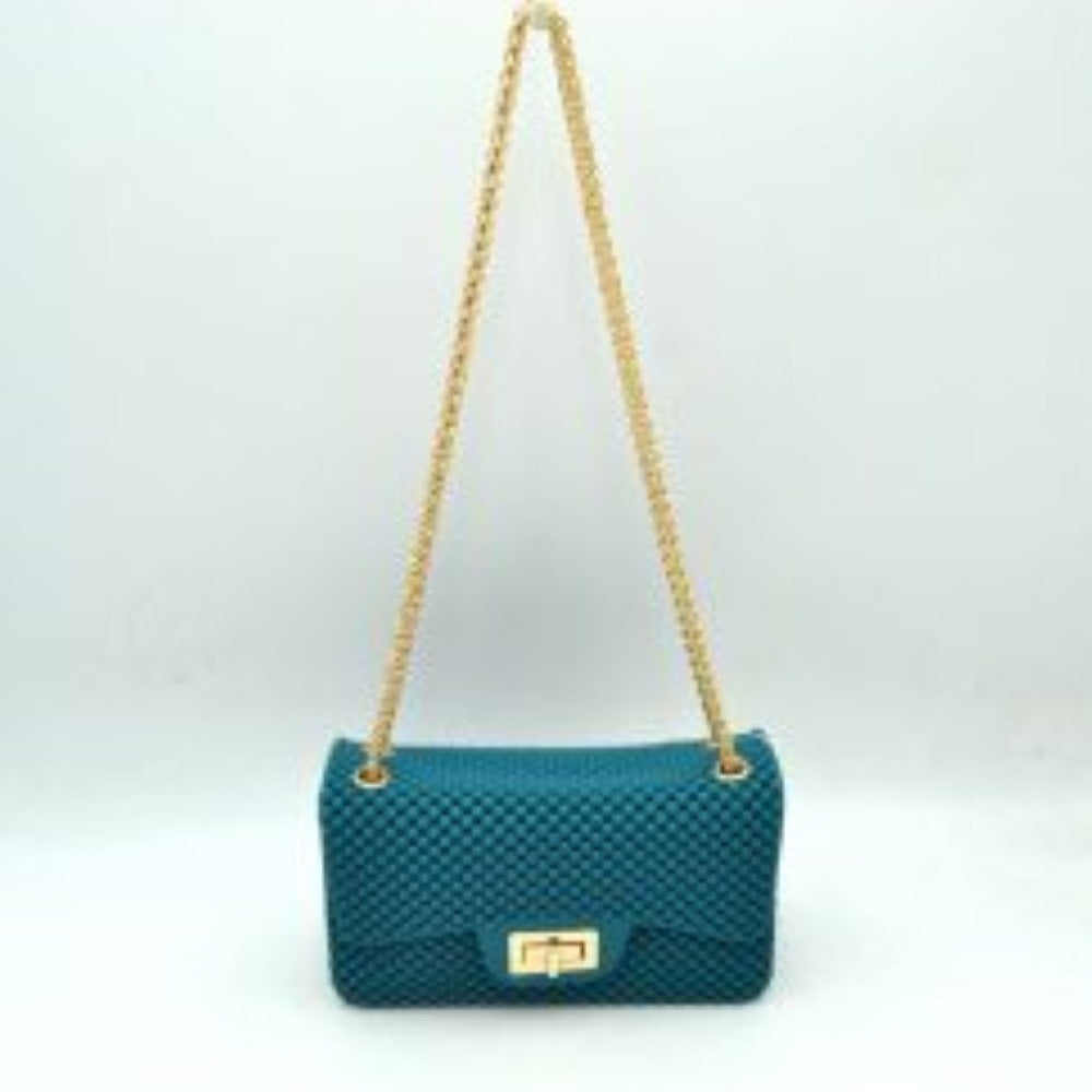 Turquoise This rectangular flap bag showcases a distinctive all-over bumpy textured design that adds unique tactile interest, making it a stylish choice for everyday use. The main storage compartment is safely secured by a front flap featuring a metallic twist-lock closure. Designed for easy carrying, the bag incorporates a long metallic chain shoulder strap fed through top eyelets, allowing it to rest comfortably on the shoulder throughout the day.