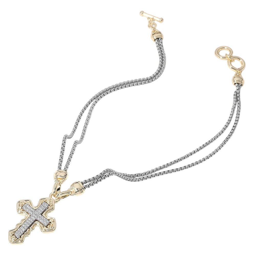 Two Tone 14K gold plated necklace features a sparkling CZ stone paved cross pendant on a double chain. Perfect for adding a touch of elegance and faith to any outfit, this necklace is a must-have for any jewelry collection. Made with superior craftsmanship and high-quality materials, it is both durable and stunning.