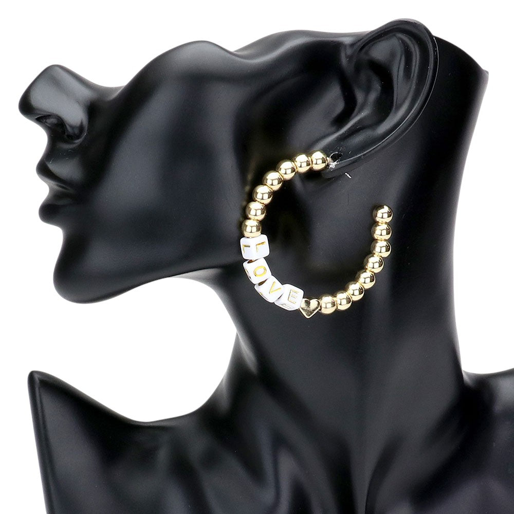 White LOVE Metal Ball Half Hoop Message Earrings are a stylish addition to any outfit. The metal ball half hoop design adds a touch of modern flair, while the LOVE message adds a sweet and romantic touch. Crafted with high-quality materials, these earrings are both fashionable and durable. Perfect for any occasion.