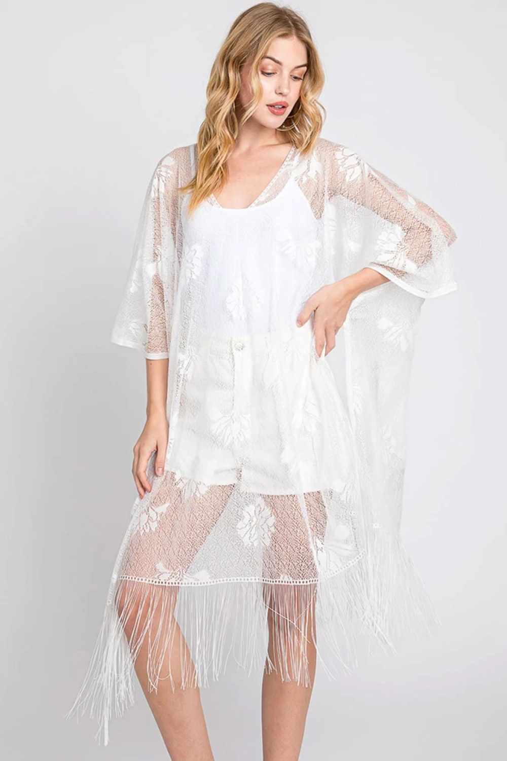 White Effortless elegance meets bohemian charm with this Floral Lace Poncho. Crafted from lightweight 100% polyester, this versatile piece features delicate floral lace detailing and playful tassels for a relaxed, layered look. Perfect for draping over dresses, swimwear, or casual outfits, it offers easy coverage with timeless appeal. Generously sized at 39" x 27", it's ideal for any season and occasion.