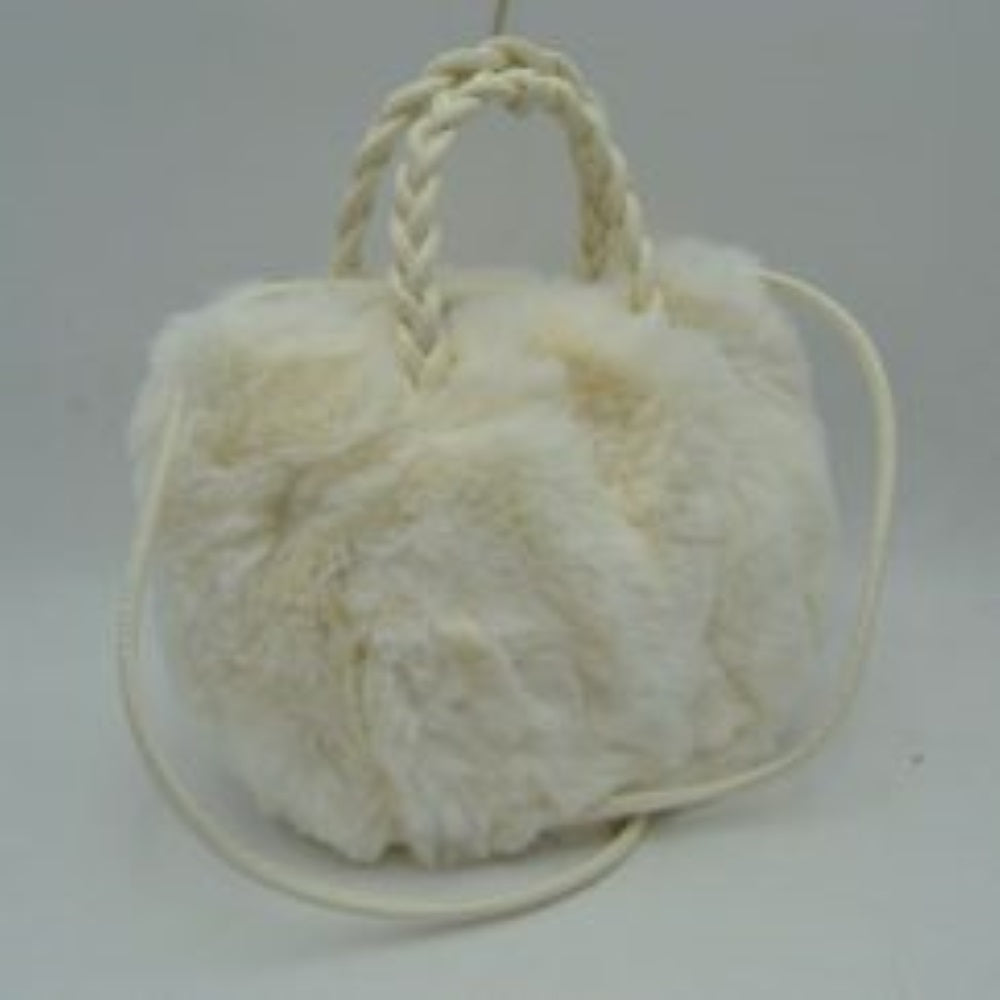 White This soft everyday bucket-style handbag features a densely textured, plush exterior that offers a cozy aesthetic for daily use. Designed with a structured yet flexible silhouette, it features dual braided top handles for comfortable hand carrying alongside a slender, long shoulder strap that provides hands-free convenience. The top opening reveals a spacious central storage compartment ideal for organizing essential items