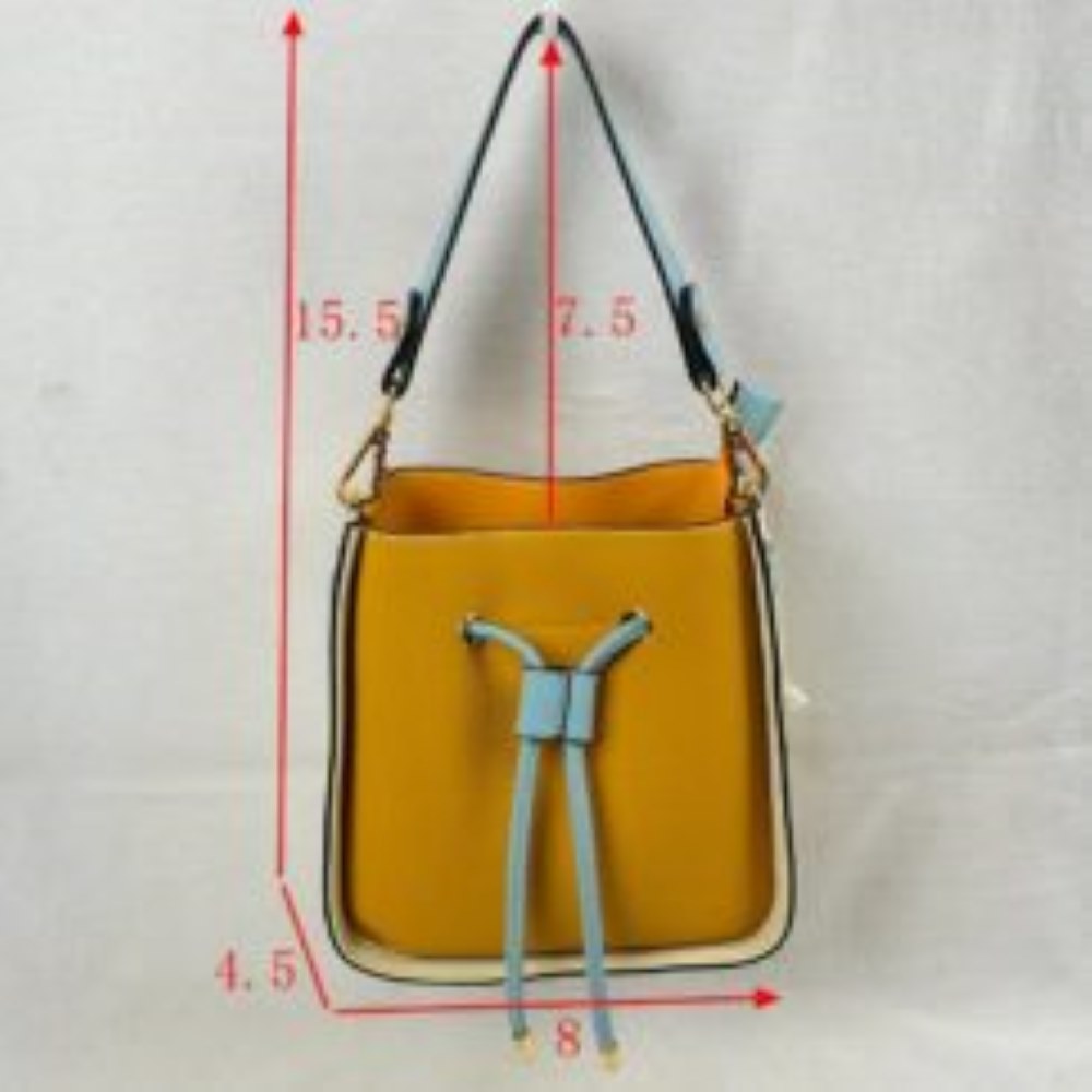 Yellow This stylish bucket bag features a distinctive color-blocked design crafted with a pebbled exterior texture, making it a versatile accessory for everyday use. The front panel includes a classic cinch drawstring closure detailed with contrasting trim and polished metallic aglets that open to a secure main storage compartment. Built for flexibility, it is equipped with a structured shoulder handle, an adjustable long shoulder strap