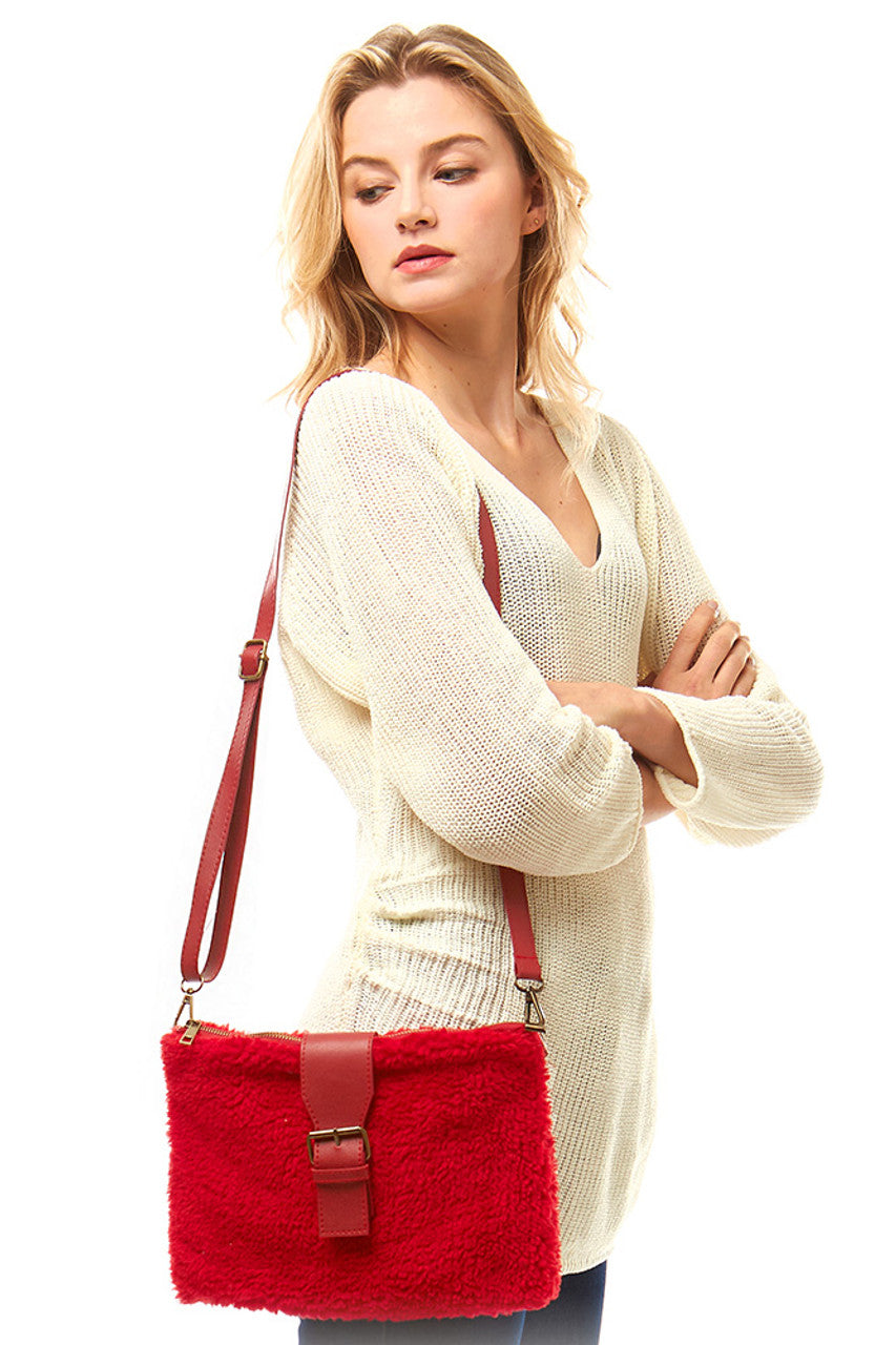 Sherpa Fleece Cross Body Bag combines cozy sherpa fleece material with practical design, offering warmth and durability for everyday use. Its crossbody style ensures hands-free convenience, while the soft texture provides comfort during wear. Ideal for carrying essentials securely, this bag is a versatile accessory for both casual outings and travel.