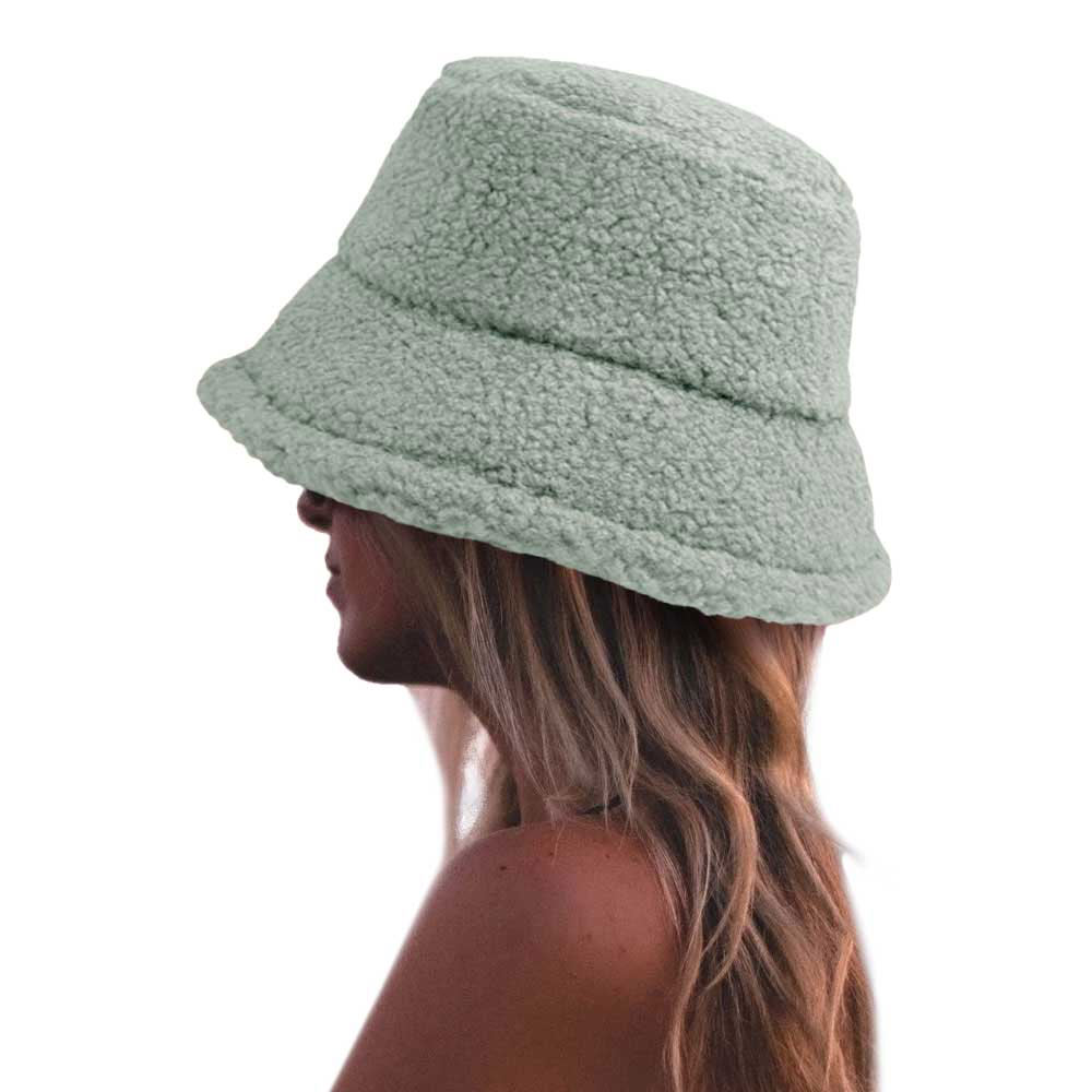 Mugwort Fluffy Bucket Hat, Show your excellent choice with this chic Faux Fur Bucket Hat. This fluffy bucket hat is nicely designed and a great addition to your attire. Have fun and look Stylish anywhere outdoors. Great for covering up when you are having a bad hair day. Perfect for protecting you from the wind, snow, beach, pool, camping, or any outdoor activities in cold weather. Amps up your outlook with confidence with this trendy bucket hat.