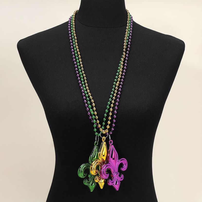 Mult Purple Fleur-de-lis pendant necklace set designed with a bold emblem charm and classic beaded chain for statement appeal. Ideal for celebrations, themed events, parades, and party styling, these necklaces add iconic flair and playful character to outfits while remaining lightweight and easy to wear.